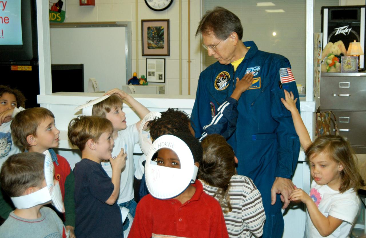 KENNEDY SPACE CENTER, FLA. -- Students at Oscar Patterson Elementary Magnet School in Panama City, Fla., are eager for a “hands-on” experience with astronaut Sam Durrance, who shared his experiences in space during the school visit.  Durrance joined Center Director Jim Kennedy, who is touring  Florida and Georgia NASA Explorer Schools to share America’s new vision  for space exploration with the next generation of explorers.  Kennedy is talking with students about our destiny as explorers, NASA’s stepping stone approach to exploring Earth, the Moon, Mars and beyond, how space impacts our lives, and how people and machines rely on each other in space.