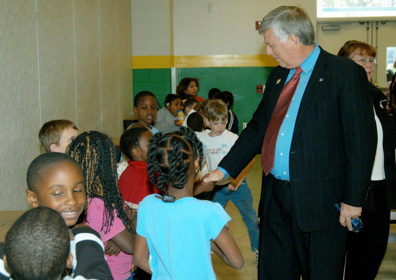 KENNEDY SPACE CENTER, FLA. -- Students at Oscar Patterson Elementary Magnet School in Panama City, Fla., are eager for a “hands-on” experience with astronaut Sam Durrance, who shared his experiences in space during the school visit.  Durrance joined Center Director Jim Kennedy, who is touring  Florida and Georgia NASA Explorer Schools to share America’s new vision  for space exploration with the next generation of explorers.  Kennedy is talking with students about our destiny as explorers, NASA’s stepping stone approach to exploring Earth, the Moon, Mars and beyond, how space impacts our lives, and how people and machines rely on each other in space.