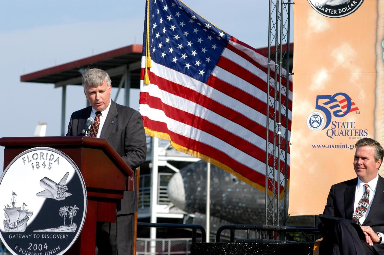 KENNEDY SPACE CENTER, FLA. -- As master of ceremonies, Center Director Jim Kennedy opens the event at the KSC Visitor Complex launching the new Florida quarter. He introduced  Florida Gov. Jeb Bush (right) who helped present the new coin.  Also participating were NASA Administrator Sean O’Keefe, Deputy Secretary of the Treasury Samuel W. Bodman and U.S. Mint Director Henrietta Holsman Fore.  The quarter celebrates Florida as a destination for explorers in the past, a launch site for future explorers into space and an inviting place for visitors today.