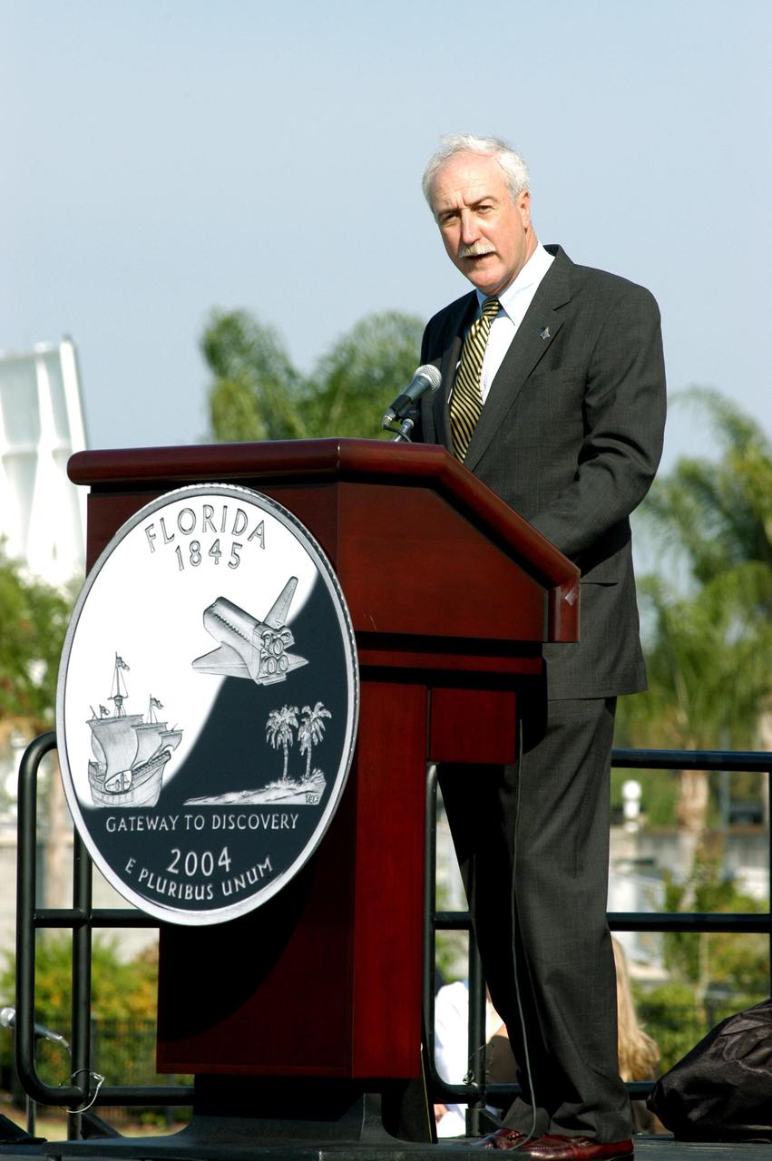 KENNEDY SPACE CENTER, FLA. -- NASA Administrator Sean O’Keefe comments on the design of the new Florida quarter during the ceremony at the KSC Visitor Complex that launched the coin.  Also participating were Center Director Jim Kennedy, who emceed, Florida Gov. Jeb Bush, U.S. Mint Director Henrietta Holsman Fore and Deputy Secretary of the Treasury Samuel W. Bodman.  The quarter celebrates Florida as a destination for explorers in the past, a launch site for future explorers into space and an inviting place for visitors today.