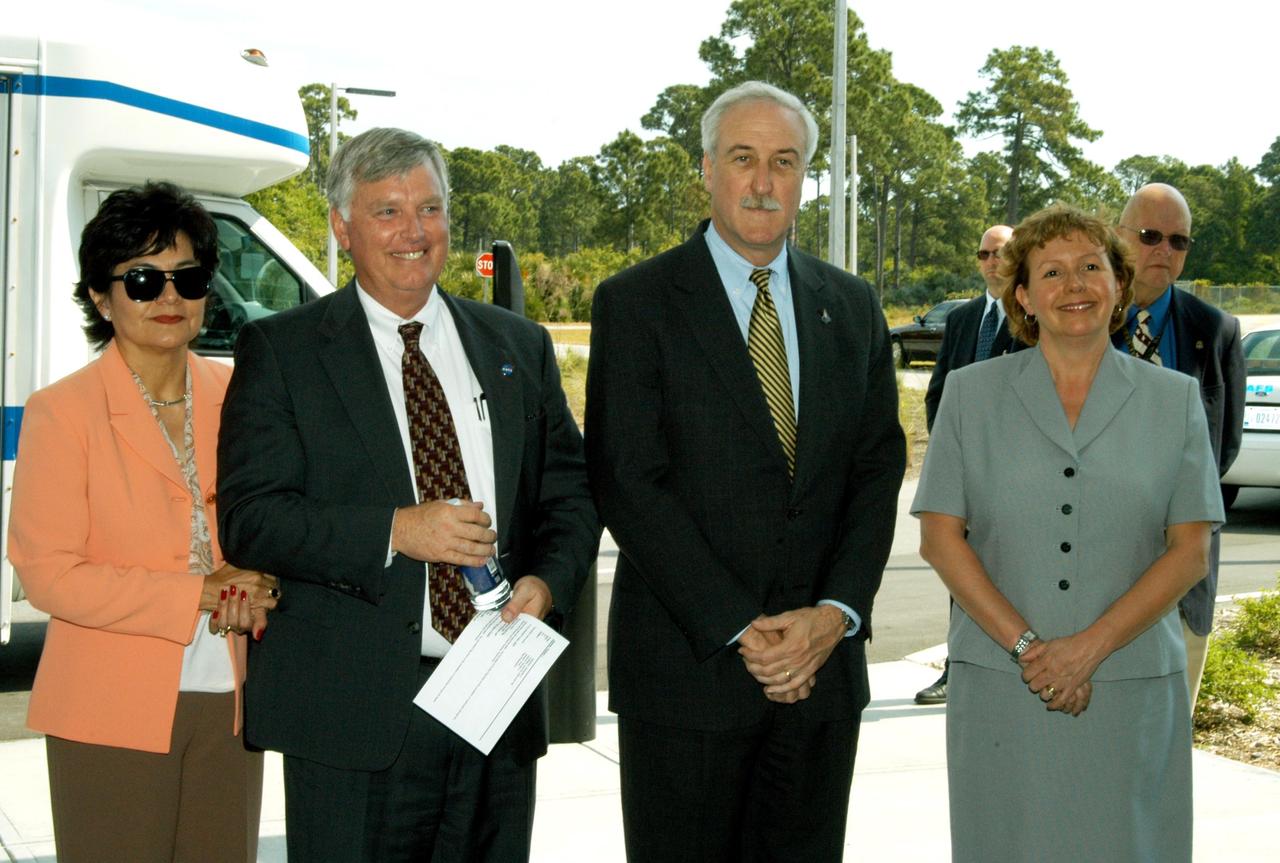 KENNEDY SPACE CENTER, FLA. -- Center Director Jim Kennedy (center left) and NASA Administrator Sean O’Keefe (center right) wait with their wives, Bernadette and Laura, respectively, for the start of a tour of KSC facilities. The new lab is a state-of-the-art facility built for ISS biotechnology research. It was developed as a partnership between NASA-KSC and the State of Florida.  The tour followed the launching ceremony at the KSC Visitor Complex for the new Florida quarter issued by the U.S. Mint. The ceremony was emceed by Kennedy and included remarks by NASA Administrator Sean O’Keefe, Gov. Jeb Bush, U.S. Mint Director Henrietta Holsman Fore and Deputy Secretary of the Treasury Samuel W. Bodman. Kennedy and O’Keefe accompanied by NASA Administrator Sean O’Keefe and Center Director Jim Kennedy and their wives.