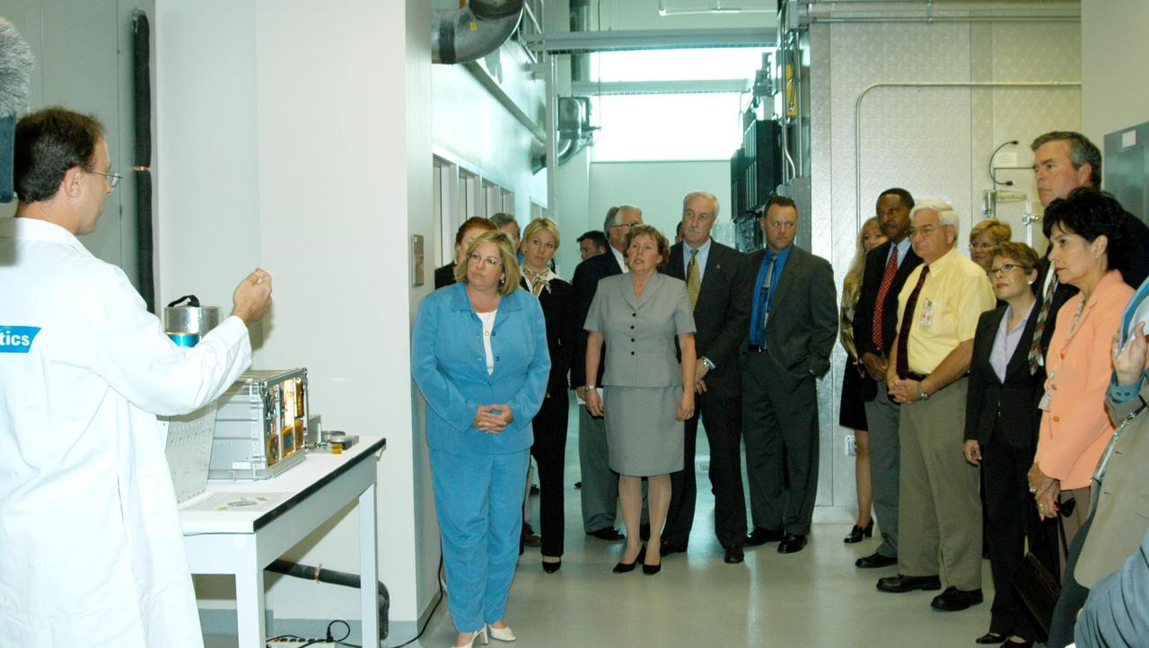 KENNEDY SPACE CENTER, FLA. -- A Dynamac worker (left) explains the function of the KSC Space Life Sciences (SLS) Lab to a prestigious tour group: in the center, Laura O’Keefe and NASA Administrator Sean O’Keefe; at right, Florida Gov. Jeb Bush flanked by his wife, Columba on the left and Bernadette Kennedy, wife of Center Director Jim Kennedy. The new lab is a state-of-the-art facility built for ISS biotechnology research. It was developed as a partnership between NASA-KSC and the State of Florida.  The tour followed the launching ceremony at the KSC Visitor Complex for the new Florida quarter issued by the U.S. Mint.  The ceremony was emceed Kennedy and included remarks by O’Keefe, Bush, U.S. Mint Director Henrietta Holsman Fore and Deputy Secretary of the Treasury Samuel W. Bodman.