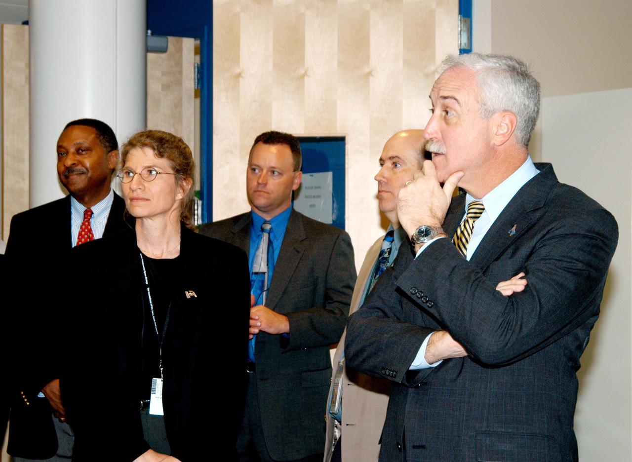 KENNEDY SPACE CENTER, FLA. -- In the KSC Space Life Sciences Lab, NASA Administrator Sean O’Keefe (far right) learns about some of the experiments being conducted. At far left is former astronaut Winston Scott; next to him is U.S. Mint Director Henrietta Holsman Fore. The new lab is a state-of-the-art facility built for ISS biotechnology research. It was developed as a partnership between NASA-KSC and the State of Florida. The tour followed the launching ceremony at the KSC Visitor Complex for the new Florida quarter issued by the U.S. Mint. The ceremony was emceed by Center Director Jim Kennedy and included remarks by O’Keefe, Bush, Fore and Deputy Secretary of the Treasury Samuel W. Bodman.