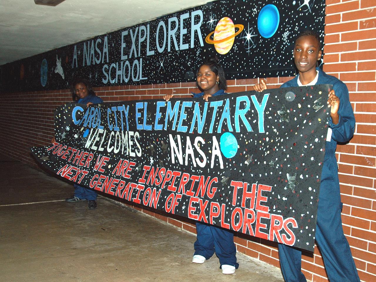 KENNEDY SPACE CENTER, FLA. - Students at Carol City Elementary School, a NASA Explorer School, in Miami, Fla., are ready to greet Center Director Jim Kennedy on his visit to the school. Kennedy made the tour to share America’s new vision for space exploration with the next generation of explorers. He was accompanied by astronaut Dr. Dr. David A. Wolf. Kennedy is talking with students about our destiny as explorers, NASA’s stepping stone approach to exploring Earth, the Moon, Mars and beyond, how space impacts our lives, and how people and machines rely on each other in space.