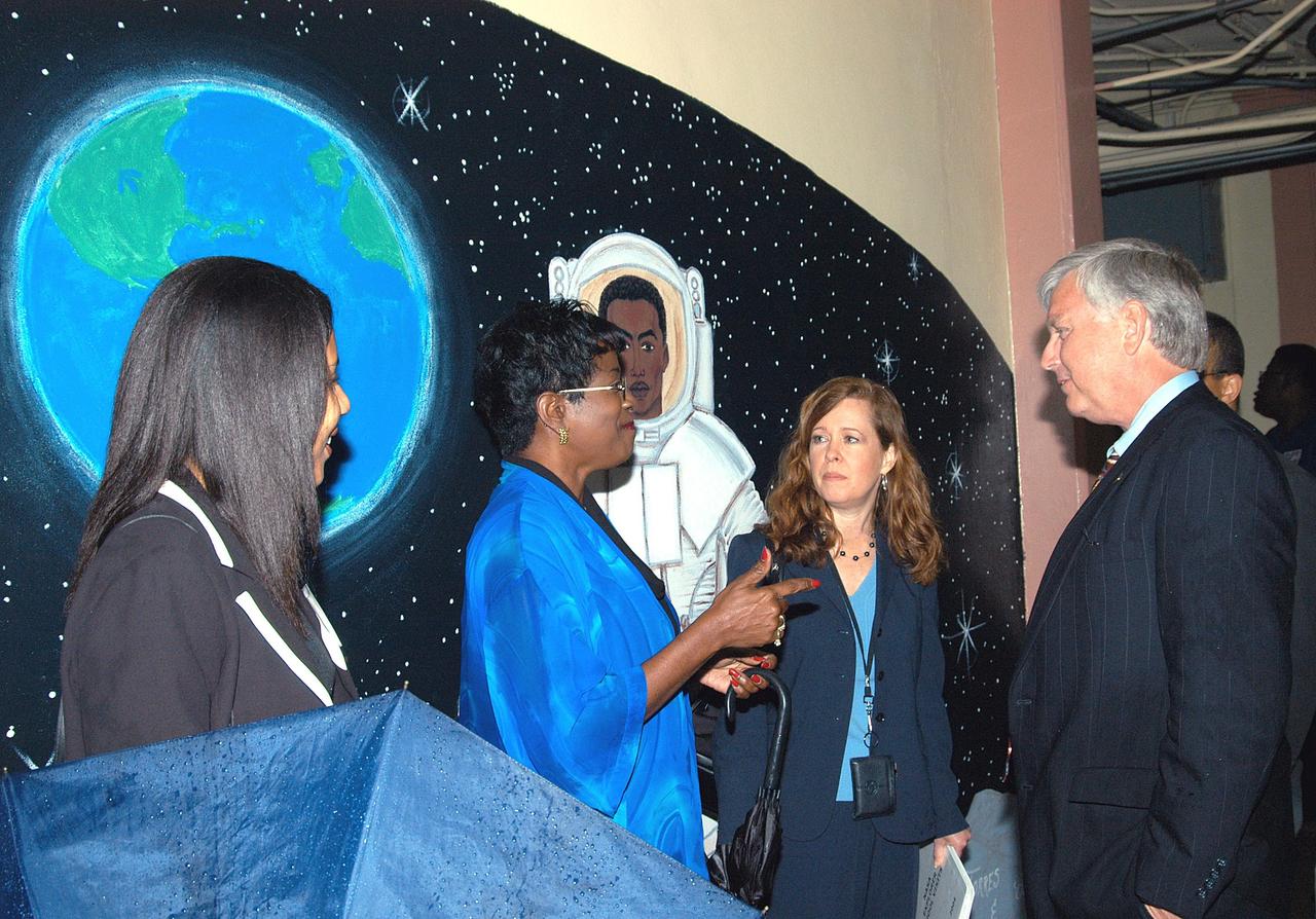 KENNEDY SPACE CENTER, FLA. - Center Director Jim Kennedy (right) and External Relations Director Lisa Malone (second from right) talk to teachers at Carol City Elementary School, a NASA Explorer School, in Miami, Fla. Kennedy made the tour to share America’s new vision for space exploration with the next generation of explorers. He was also accompanied by astronaut Dr. David A. Wolf. Kennedy is talking with students about our destiny as explorers, NASA’s stepping stone approach to exploring Earth, the Moon, Mars and beyond, how space impacts our lives, and how people and machines rely on each other in space.