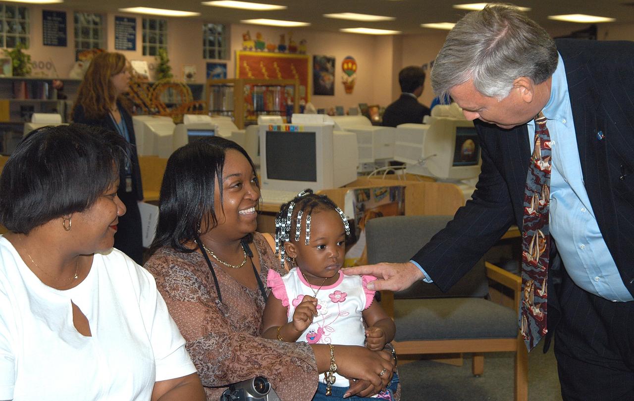 KENNEDY SPACE CENTER, FLA. - - Center Director Jim Kennedy greets a mother and daughter while on a visit to Carol City Elementary School, a NASA Explorer School, in Miami, Fla. Kennedy made the tour to share America’s new vision for space exploration with the next generation of explorers. He was accompanied by astronaut Dr. David A. Wolf. Kennedy is talking with students about our destiny as explorers, NASA’s stepping stone approach to exploring Earth, the Moon, Mars and beyond, how space impacts our lives, and how people and machines rely on each other in space.