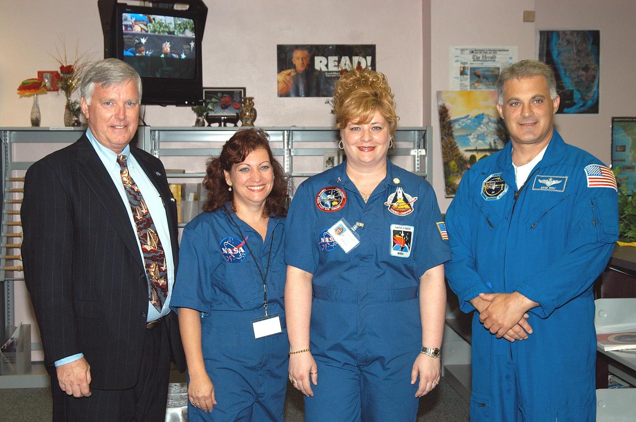 KENNEDY SPACE CENTER, FLA. - Center Director Jim Kennedy (left) and astronaut Dr. David A. Wolf flank two of the teachers at Carol City Elementary School, a NASA Explorer School, in Miami, Fla., which Kennedy visited to share America’s new vision for space exploration with the next generation of explorers. Kennedy is talking with students about our destiny as explorers, NASA’s stepping stone approach to exploring Earth, the Moon, Mars and beyond, how space impacts our lives, and how people and machines rely on each other in space.
