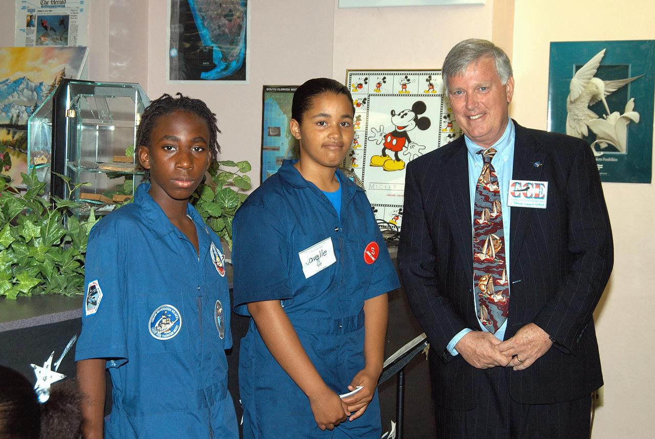 KENNEDY SPACE CENTER, FLA. -  Center Director Jim Kennedy (right) is joined by two students at Carol City Elementary School, a NASA Explorer School, in Miami, Fla., which Kennedy visited to share America’s new vision for space exploration with the next generation of explorers. Kennedy is talking with students about our destiny as explorers, NASA’s stepping stone approach to exploring Earth, the Moon, Mars and beyond, how space impacts our lives, and how people and machines rely on each other in space.