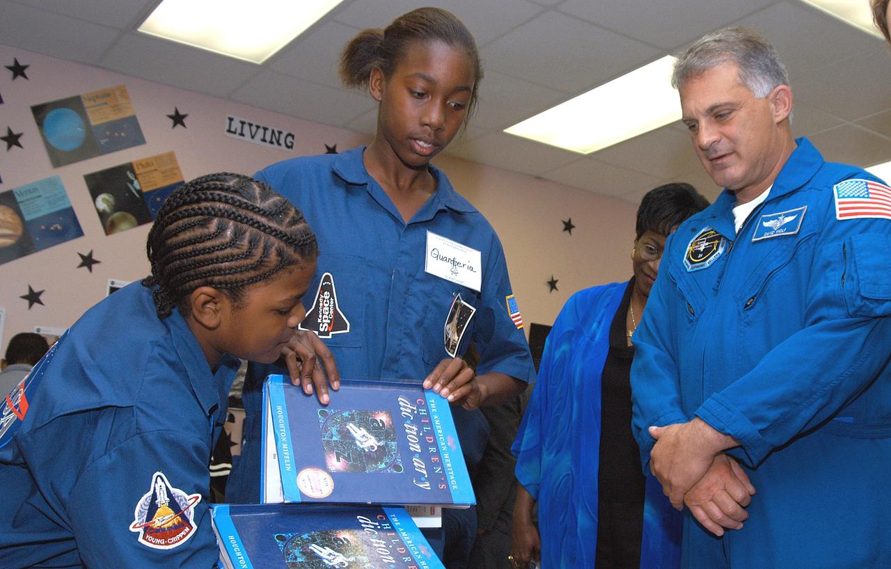 KENNEDY SPACE CENTER, FLA. - Astronaut Dr. David A. Wolf (right) talks to students during a visit to Carol City Elementary School, a NASA Explorer School, in Miami, Fla. Wolf accompanied Center Director Jim Kennedy, who is sharing America’s new vision for space exploration with the next generation of explorers. Kennedy is talking with students about our destiny as explorers, NASA’s stepping stone approach to exploring Earth, the Moon, Mars and beyond, how space impacts our lives, and how people and machines rely on each other in space.