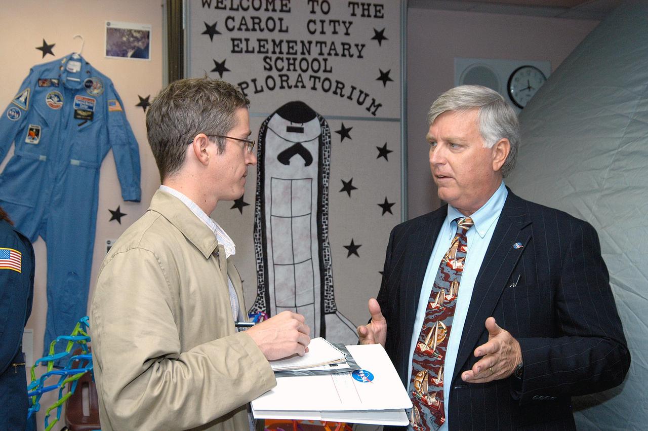 KENNEDY SPACE CENTER, FLA. -  Center Director Jim Kennedy (right) talks to a reporter from the Miami Herald about his visit to Carol City Elementary School, a NASA Explorer School, in Miami, Fla.  Kennedy is sharing America’s new vision for space exploration with the next generation of explorers. He is talking with students about our destiny as explorers, NASA’s stepping stone approach to exploring Earth, the Moon, Mars and beyond, how space impacts our lives, and how people and machines rely on each other in space.