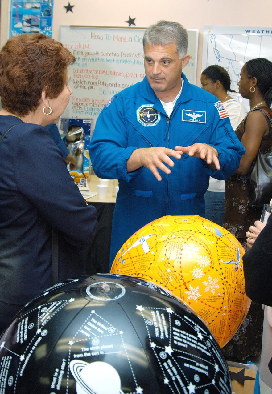 KENNEDY SPACE CENTER, FLA. - Astronaut Dr. David A. Wolf talks to a teacher about students’ projects in a class at Carol City Elementary School, a NASA Explorer School, in Miami, Fla. Wolf is accompanying Center Director Jim Kennedy on a visit to the school to share America’s new vision for space exploration with the next generation of explorers. Kennedy is talking with students about our destiny as explorers, NASA’s stepping stone approach to exploring Earth, the Moon, Mars and beyond, how space impacts our lives, and how people and machines rely on each other in space.