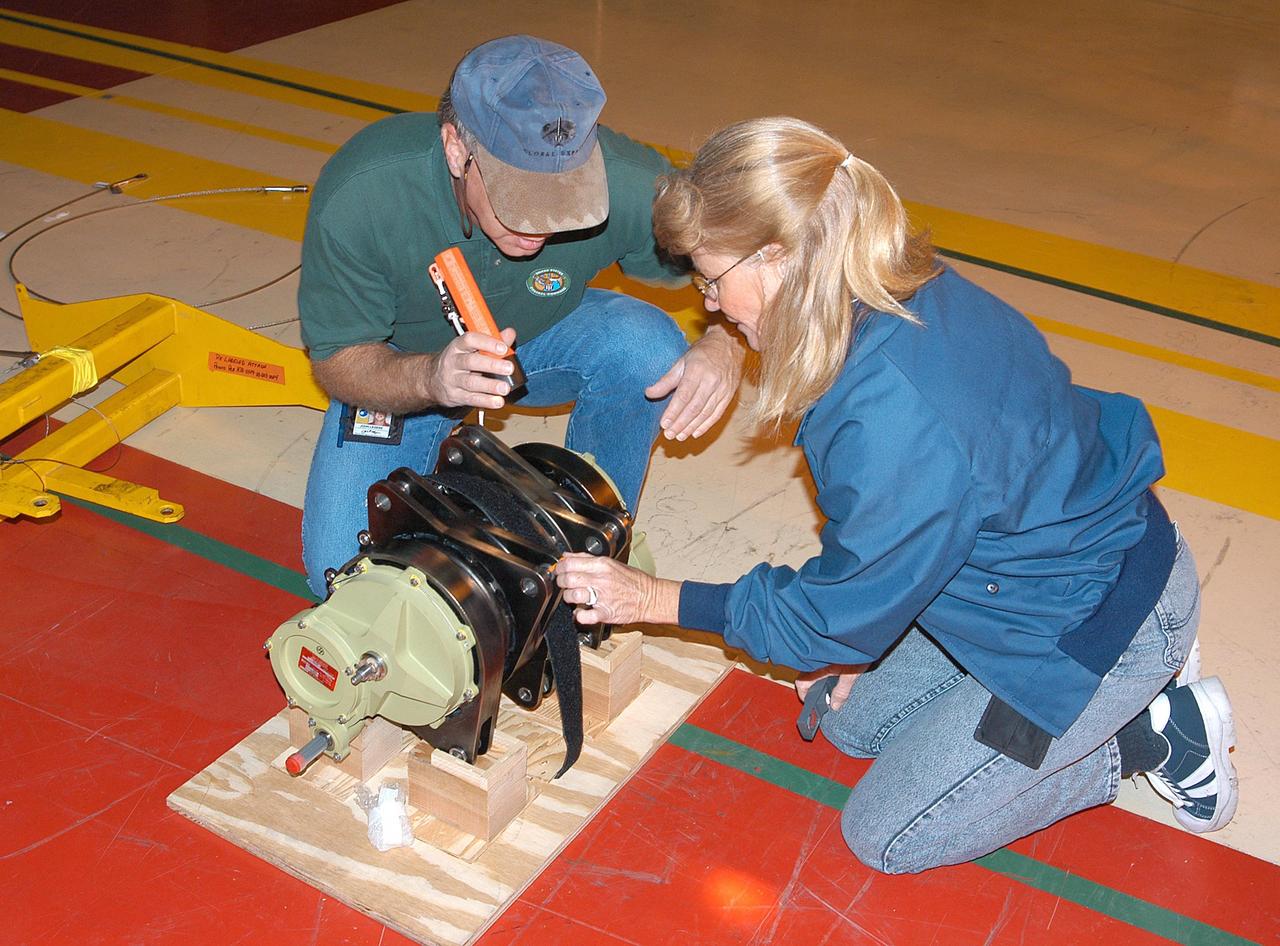 KENNEDY SPACE CENTER, FLA. - United Space Alliance technicians check out Rudder Speed Brake actuator No. 4 before installing it on Space Shuttle orbiter Discovery in the Orbiter Processing Facility. Discovery has been assigned to the first Return to Flight mission, STS-114, a logistics flight to the International Space Station.