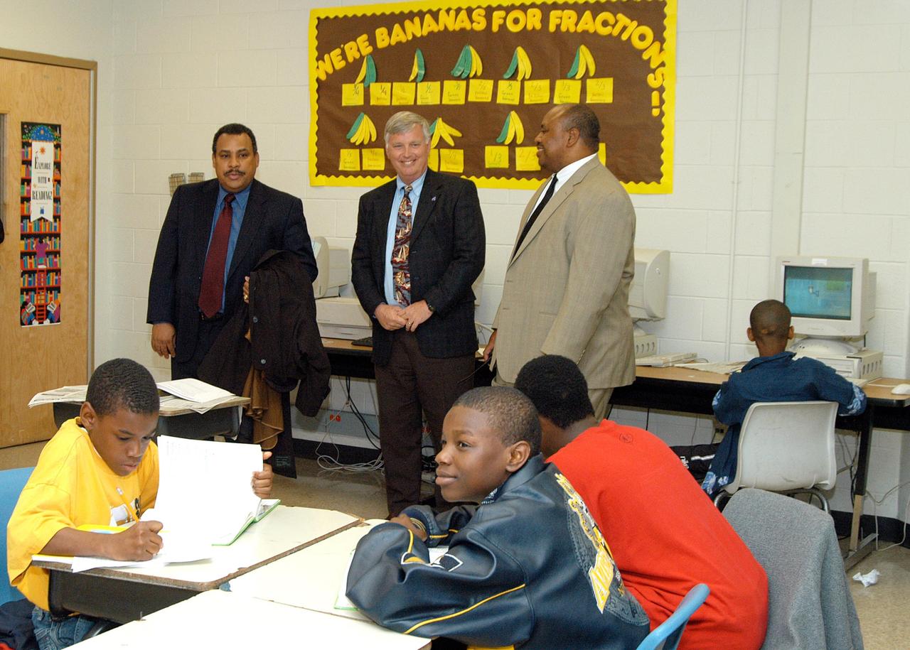 KENNEDY SPACE CENTER, FLA. -   Center Director Jim Kennedy (center) and Principal Aaron Fernander (right) visit a classroom in Ralph Bunche Middle School, a NASA Explorer School, in Atlanta, Ga.  At left is Ralph Thomas, assistant administrator for Small and Disadvantaged Business Utilization at NASA. Kennedy is visiting NES sites to share America’s new vision for space exploration with the next generation of explorers. He was accompanied by astronaut Rick Linnehan on the visit.  The purpose of the school visit is to talk with students about our destiny as explorers, NASA’s stepping stone approach to exploring Earth, the Moon, Mars and beyond, how space impacts our lives, and how people and machines rely on each other in space.
