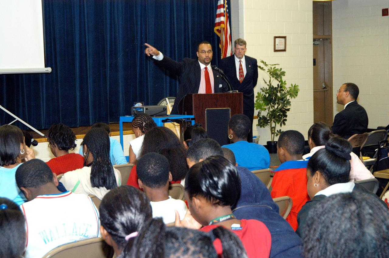 KENNEDY SPACE CENTER, FLA. -   Warren Edwards, at the podium, with the Aerospace Education Services Program (AESP) at Langley Research Center, Hampton, Va.,  speaks to students and faculty at  Ralph Bunche Middle School, a NASA Explorer School, in Atlanta, Ga.  On the right is Jim Gerard, also with AESP.  They accompanied Center Director Jim Kennedy, who is visiting NES sites to share America’s new vision for space exploration with the next generation of explorers.  The purpose of the school visit is to talk with students about our destiny as explorers, NASA’s stepping stone approach to exploring Earth, the Moon, Mars and beyond, how space impacts our lives, and how people and machines rely on each other in space.