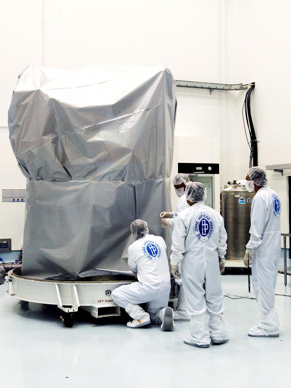 KENNEDY SPACE CENTER, FLA. - - Workers at Astrotech Space Operations facilities in Titusville, Fla., secure the cover on the MESSENGER (Mercury Surface, Space Environment, Geochemistry and Ranging) spacecraft for a move from its current location in the hazardous processing facility, where it has been since arrival March 10, to an adjacent nonhazardous payload processing facility. The remainder of its final assembly and testing will be completed there. The spacecraft will return to the hazardous processing facility when ready for fueling, spin balance testing and mating to the upper stage. MESSENGER is scheduled to launch no earlier than July 30 from Cape Canaveral Air Force Station. MESSENGER is a scientific investigation of the planet Mercury, the least explored terrestrial planet. Understanding Mercury and how it was formed is essential to understanding the other terrestrial planets and their evolution. The MESSENGER mission will orbit Mercury after making two flybys of the planet, using data collected during the flybys as an initial guide to perform a more focused scientific investigation of this mysterious world. The spacecraft will enter Mercury orbit in March 2011 and carry out comprehensive measurements for one full Earth year.