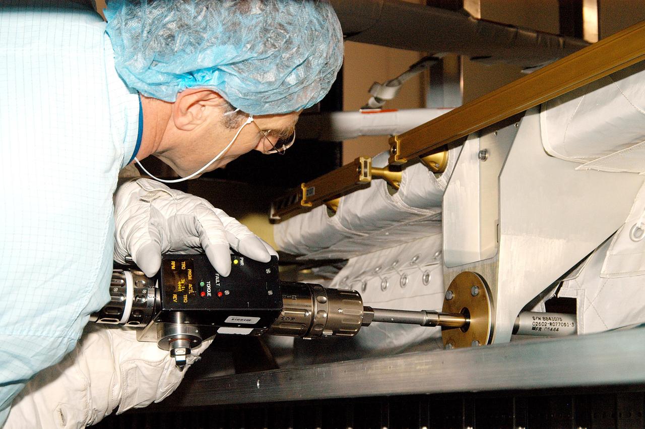 KENNEDY SPACE CENTER, FLA. - STS-118 Mission Specialist Dafydd Williams (Canadian Space Agency) practices using a tool that is part of equipment for the mission. The crew is taking part in equipment familiarization in the Space Station Processing Facility. The STS-118 mission will be delivering and installing the third starboard truss segment, the ITS S5, to the International Space Station, and carry a SPACEHAB Single Cargo Module with supplies and equipment. Launch date is under review.