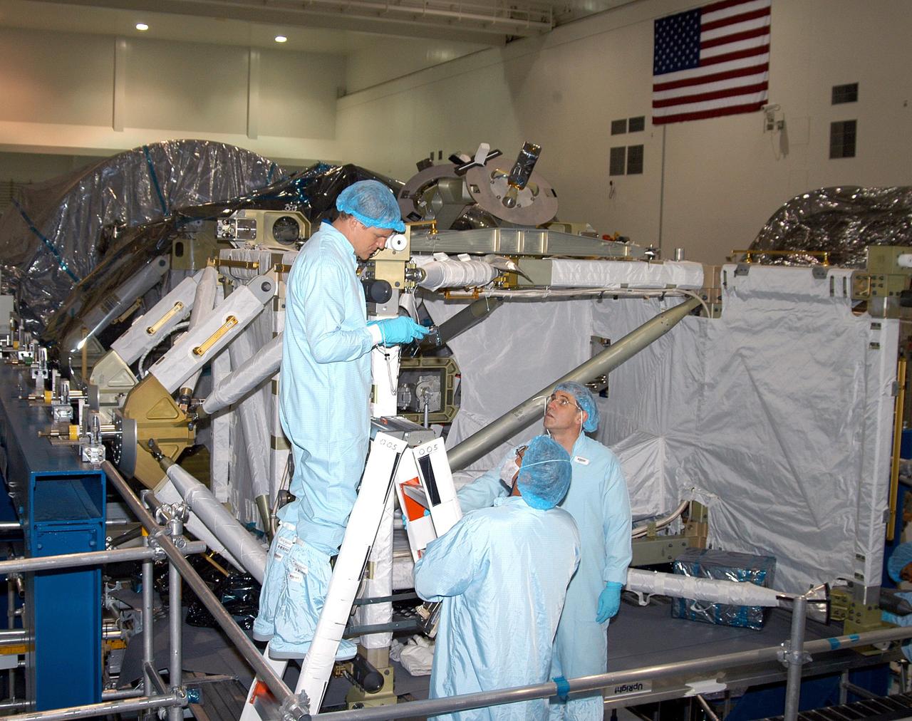 KENNEDY SPACE CENTER, FLA. -  In the Space Station Processing Facility, STS-118 crew members practice using equipment for the mission.  At left, on the ladder, is Mission Specialist Scott Parazynski; on the right, looking up, is Mission Specialist Dafydd Williams (Canadian Space Agency).  The STS-118 mission will be delivering and installing the third starboard truss segment, the ITS S5, to the International Space Station, and carry a SPACEHAB Single Cargo Module with supplies and equipment.  Launch date is under review.
