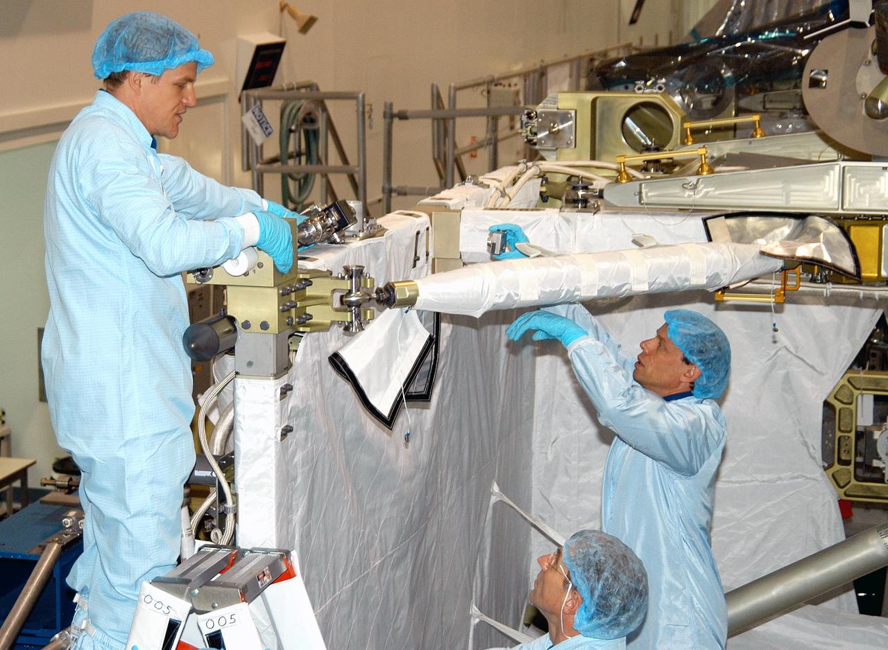 KENNEDY SPACE CENTER, FLA. - STS-118 Mission Specialist Scott Parazynski (left) practices using a tool that is part of equipment for the mission to the International Space Station. Below is Mission Specialist Dafydd Williams (Canadian Space Agency). At right is STS-116 Mission Specialist Christer Fuglesang (European Space Agency), also taking part in the equipment familiarization. The STS-118 mission will be delivering and installing the third starboard truss segment, the ITS S5, to the International Space Station, and carry a SPACEHAB Single Cargo Module with supplies and equipment. The STS-116 mission will deliver the third port truss segment, the P5 Truss, to attach to the second port truss segment, the P3/P4 Truss. Launch dates for both missions are under review.