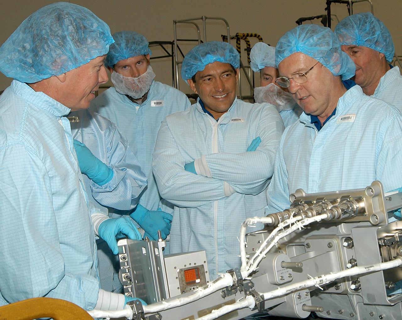 KENNEDY SPACE CENTER, FLA. - In the Space Station Processing Facility, members of several Space Shuttle mission crews get a close look at the Video Stanchion Support Assembly (VSSA) that will fly on STS-114 (Logistics Flight 1).   At left is STS-116 Mission Specialist Christer Fuglesang (European Space Agency), at center is STS-121 Mission Specialist Carlos Noriega, and at right is STS-114 Mission Specialist Andrew Thomas. The crews are at KSC for equipment familiarization.