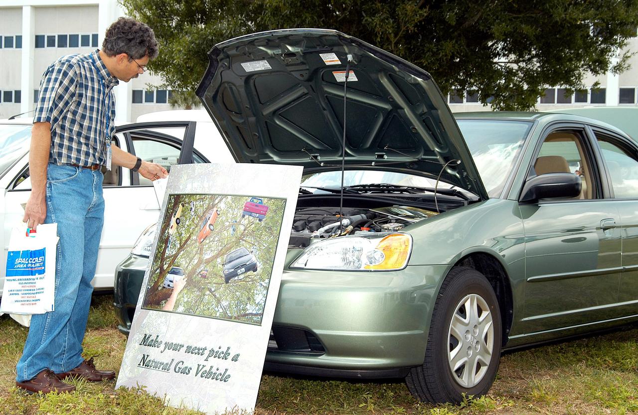 KENNEDY SPACE CENTER, FLA. - A KSC employee stops to look at a car equipped to use natural gas as fuel.  Several cars using alternative fuel technology were part of an exhibit during KSC’s annual Environmental and Energy Awareness Week, held April 20-22.  The slogan for this year’s event was “Today's Conservation Defines Tomorrow's Future.”  Presentations included Chemistry Safety, Cost-Effective Solar Applications, Non-Native Invasive Plant Identification and Control, Energy Efficient Lighting Systems, and Historical Changes in KSC’s Ecosystems.