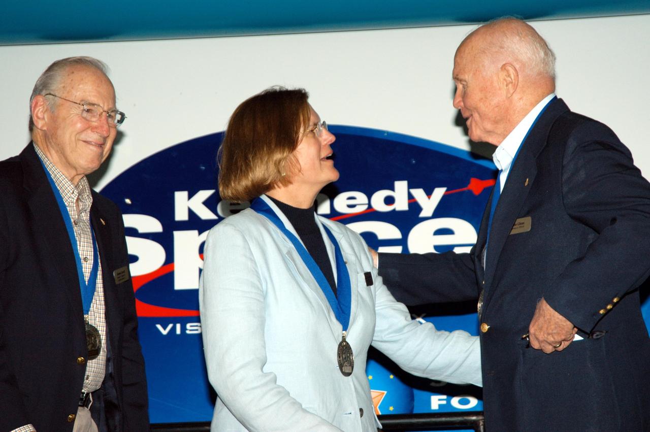 KENNEDY SPACE CENTER, FLA. -- At the Kennedy Space Center Visitor Complex, former NASA astronaut John H. Glenn Jr. (right) congratulates former NASA astronaut and fellow Ohioan Kathryn D. Sullivan on her induction into the U.S. Astronaut Hall of Fame. Former NASA astronaut James A. Lovell Jr. looks on (left). Sullivan was the first American woman to walk in space. Also chosen for this honor in 2004 are Richard O. Covey, commander of the Hubble Space Telescope repair mission; Frederick D. Gregory, the first African-American to command a space mission; Norman E. Thagard, the first American to occupy Russia's Mir space station; and the late Francis R. "Dick" Scobee, commander of the ill-fated 1986 Challenger mission. The U.S. Astronaut Hall of Fame opened in 1990 to provide a place where space travelers could be remembered for their participation and accomplishments in the U.S. space program. To be eligible for induction, an individual must have been a U.S. citizen, a NASA astronaut, and out of the active astronaut corps at least five years. The five inductees join 52 previously honored astronauts from the ranks of the Gemini, Apollo, Skylab, Apollo-Soyuz, and Space Shuttle programs.