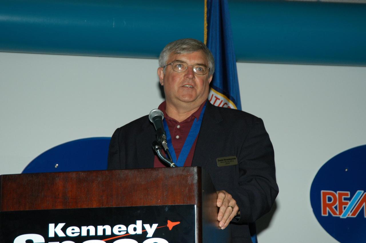 KENNEDY SPACE CENTER, FLA. -- At the Kennedy Space Center Visitor Complex, former NASA astronaut Daniel C. Brandenstein participates in the 2004 U.S. Astronaut Hall of Fame induction ceremony. He is introducing inductee Frederick D. Gregory, the first African-American to command a space mission and the current NASA Deputy Administrator. Also chosen for this honor in 2004 are Kathryn D. Sullivan, the first American woman to walk in space; Richard O. Covey, commander of the Hubble Space Telescope repair mission; Norman E. Thagard, the first American to occupy Russia's Mir space station; and the late Francis R. "Dick" Scobee, commander of the ill-fated 1986 Challenger mission. The U.S. Astronaut Hall of Fame opened in 1990 to provide a place where space travelers could be remembered for their participation and accomplishments in the U.S. space program. To be eligible for induction, an individual must have been a U.S. citizen, a NASA astronaut, and out of the active astronaut corps at least five years. The five inductees join 52 previously honored astronauts from the ranks of the Gemini, Apollo, Skylab, Apollo-Soyuz, and Space Shuttle programs.