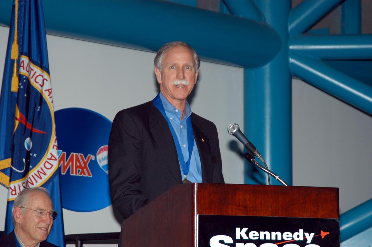 KENNEDY SPACE CENTER, FLA. -- At the Kennedy Space Center Visitor Complex, former NASA astronaut Richard O. Covey (at podium) is inducted into the U.S. Astronaut Hall of Fame as former NASA astronaut James A. Lovell Jr. looks on. Covey was commander of the Hubble Space Telescope repair mission. Also chosen for this honor in 2004 are Kathryn D. Sullivan, the first American woman to walk in space; Frederick D. Gregory, the first African-American to command a space mission; Norman E. Thagard, the first American to occupy Russia's Mir space station; and the late Francis R. "Dick" Scobee, commander of the ill-fated 1986 Challenger mission. The U.S. Astronaut Hall of Fame opened in 1990 to provide a place where space travelers could be remembered for their participation and accomplishments in the U.S. space program. To be eligible for induction, an individual must have been a U.S. citizen, a NASA astronaut, and out of the active astronaut corps at least five years. The five inductees join 52 previously honored astronauts from the ranks of the Gemini, Apollo, Skylab, Apollo-Soyuz, and Space Shuttle programs.