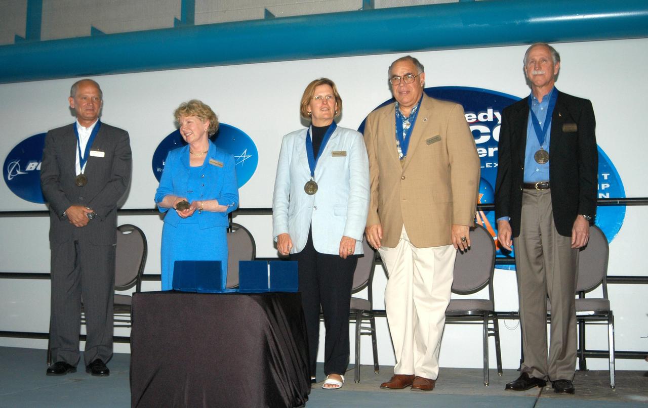 KENNEDY SPACE CENTER, FLA. -- At the Kennedy Space Center Visitor Complex, five space program heroes accept the accolades of the crowd attending their induction into the U.S. Astronaut Hall of Fame. From left, they are Norman E. Thagard, the first American to occupy Russia's Mir space station; June Scobee, on behalf of her late husband Francis R. "Dick" Scobee, commander of the ill-fated 1986 Challenger mission; Kathryn D. Sullivan, the first American woman to walk in space; Frederick D. Gregory, the first African-American to command a space mission and the current NASA Deputy Administrator; and Richard O. Covey, commander of the Hubble Space Telescope repair mission. The U.S. Astronaut Hall of Fame opened in 1990 to provide a place where space travelers could be remembered for their participation and accomplishments in the U.S. space program. To be eligible for induction, an individual must have been a U.S. citizen, a NASA astronaut, and out of the active astronaut corps at least five years. The five inductees join 52 previously honored astronauts from the ranks of the Gemini, Apollo, Skylab, Apollo-Soyuz, and Space Shuttle programs.