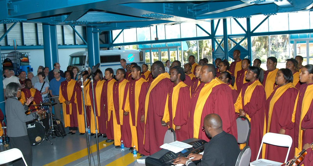 KENNEDY SPACE CENTER, FLA. --  Inside the Apollo/Saturn V Center at the Kennedy Space Center Visitor Complex, the Bethune-Cookman Choir performs prior to the induction ceremony of five space program heroes into the U.S. Astronaut Hall of Fame.  New inductees are Richard O. Covey, commander of the Hubble Space Telescope repair mission; Norman E. Thagard, the first American to occupy Russia’s Mir space station; the late Francis R. "Dick" Scobee, commander of the ill-fated 1986 Challenger mission; Kathryn D. Sullivan, the first American woman to walk in space; and Frederick D. Gregory, the first African-American to command a space mission and the current NASA deputy administrator. The U.S. Astronaut Hall of Fame opened in 1990 to provide a place where space travelers could be remembered for their participation and accomplishments in the U.S. space program. To be eligible for induction, an individual must have been a U.S. citizen, a NASA astronaut, and out of the active astronaut corps at least five years. The five inductees join 52 previously honored astronauts from the ranks of the Gemini, Apollo, Skylab, Apollo-Soyuz, and Space Shuttle programs.