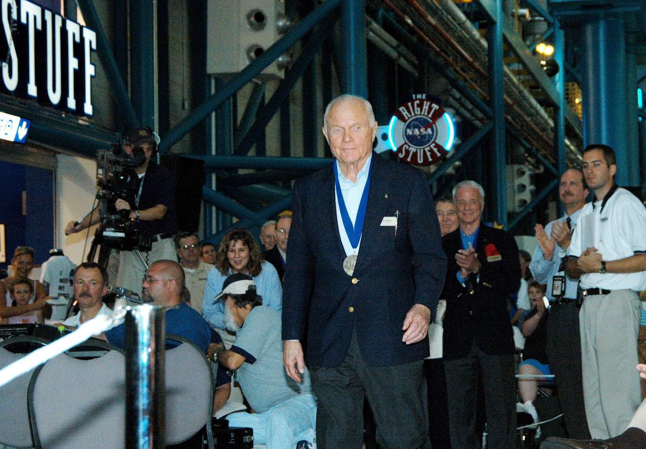KENNEDY SPACE CENTER, FLA. --  Before the induction ceremony of five space program heroes into the U.S. Astronaut Hall of Fame, former astronaut John Glenn Jr. is greeted with applause as he is introduced as a previous inductee.  One of America's original Mercury Seven astronauts, in 1962 he became the first American to orbit the Earth. Twenty-six years later, at age 77, he spent nine days in space aboard Space Shuttle Discovery.  The ceremony was held at the Apollo/Saturn V Center at KSC.  New inductees are Richard O. Covey, commander of the Hubble Space Telescope repair mission; Norman E. Thagard, the first American to occupy Russia’s Mir space station; the late Francis R. "Dick" Scobee, commander of the ill-fated 1986 Challenger mission; Kathryn D. Sullivan, the first American woman to walk in space; and Frederick D. Gregory, the first African-American to command a space mission and the current NASA deputy administrator. The U.S. Astronaut Hall of Fame opened in 1990 to provide a place where space travelers could be remembered for their participation and accomplishments in the U.S. space program. The five inductees join 52 previously honored astronauts from the ranks of the Gemini, Apollo, Skylab, Apollo-Soyuz, and Space Shuttle programs.