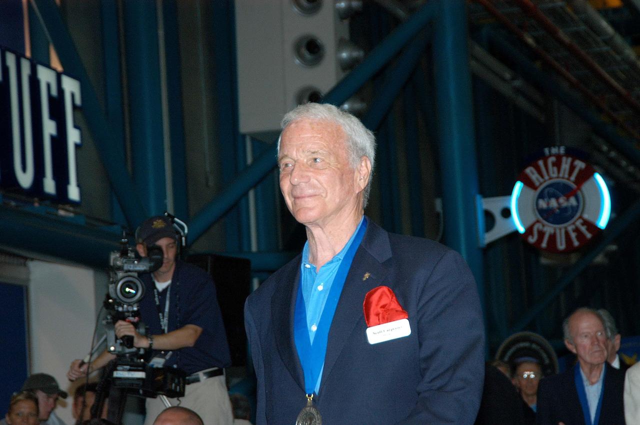 KENNEDY SPACE CENTER, FLA.  -  Former astronaut Scott Carpenter is introduced as a previous inductee into the U.S. Astronaut Hall of Fame. He and other Hall of Fame members were present for the induction of five new space program heroes into the U.S. Astronaut Hall of Fame: Richard O. Covey, commander of the Hubble Space Telescope repair mission; Norman E. Thagard, the first American to occupy Russia’s Mir space station; the late Francis R. "Dick" Scobee, commander of the ill-fated 1986 Challenger mission; Kathryn D. Sullivan, the first American woman to walk in space; and Frederick D. Gregory, the first African-American to command a space mission and the current NASA deputy administrator. The induction ceremony was held at the Apollo/Saturn V Center at KSC. The U.S. Astronaut Hall of Fame opened in 1990 to provide a place where space travelers could be remembered for their participation and accomplishments in the U.S. space program. The five inductees join 52 previously honored astronauts from the ranks of the Gemini, Apollo, Skylab, Apollo-Soyuz, and Space Shuttle programs.