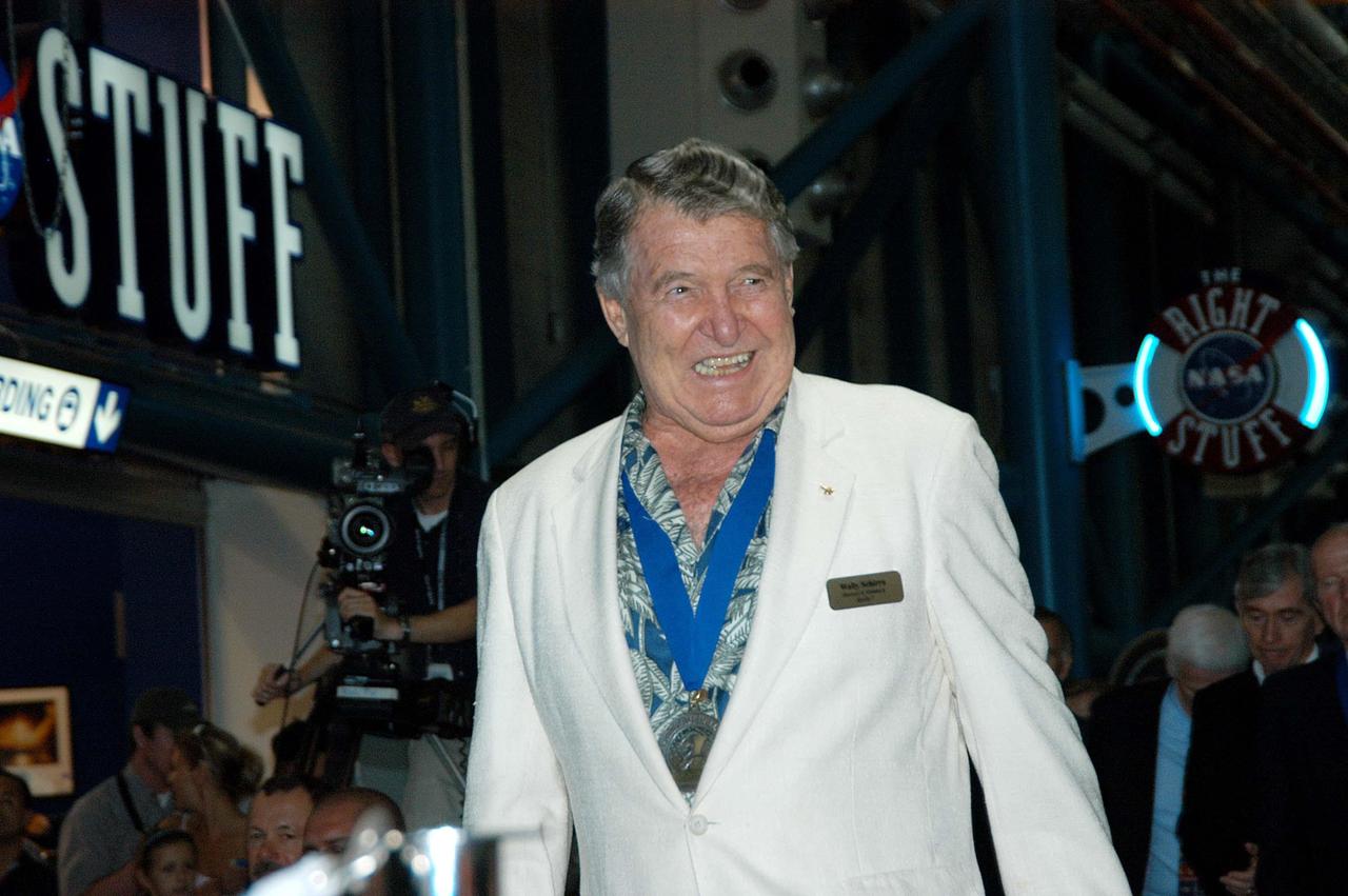 KENNEDY SPACE CENTER, FLA. --  Before the induction ceremony of five space program heroes into the U.S. Astronaut Hall of Fame, former astronaut Wally Schirra is greeted with applause as he is introduced as a previous inductee.  One of America's original Mercury Seven astronauts, Schirra is  the only one who flew in all three of the nation's pioneering space programs, Mercury, Gemini, and Apollo. The ceremony was held at the Apollo/Saturn V Center at KSC.  New inductees are Richard O. Covey, commander of the Hubble Space Telescope repair mission; Norman E. Thagard, the first American to occupy Russia’s Mir space station; the late Francis R. "Dick" Scobee, commander of the ill-fated 1986 Challenger mission; Kathryn D. Sullivan, the first American woman to walk in space; and Frederick D. Gregory, the first African-American to command a space mission and the current NASA deputy administrator. The U.S. Astronaut Hall of Fame opened in 1990 to provide a place where space travelers could be remembered for their participation and accomplishments in the U.S. space program. The five inductees join 52 previously honored astronauts from the ranks of the Gemini, Apollo, Skylab, Apollo-Soyuz, and Space Shuttle programs.