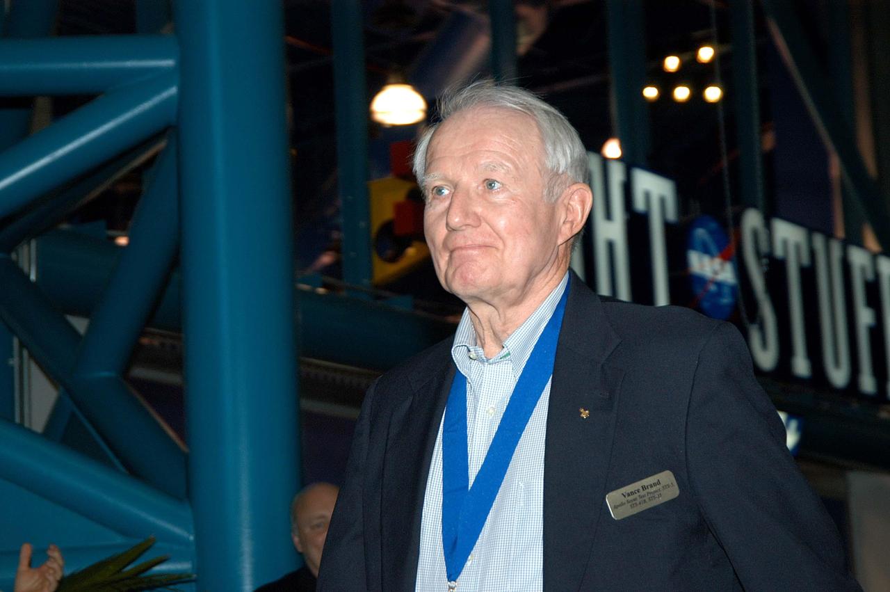 KENNEDY SPACE CENTER, FLA. --  Former astronaut Vance Brand is introduced as a previous inductee into the U.S. Astronaut Hall of Fame.  He and other  Hall of Fame members were present for the induction of five new space program heroes into the U.S. Astronaut Hall of Fame: Richard O. Covey, commander of the Hubble Space Telescope repair mission; Norman E. Thagard, the first American to occupy Russia’s Mir space station; the late Francis R. "Dick" Scobee, commander of the ill-fated 1986 Challenger mission; Kathryn D. Sullivan, the first American woman to walk in space; and Frederick D. Gregory, the first African-American to command a space mission and the current NASA deputy administrator.  Brand was Command Module Pilot on the 1975 Apollo-Soyuz Test Project, the first linkup in orbit between spaceships of the United States and Soviet Union, and he later commanded three Space Shuttle missions. The induction ceremony was held at the Apollo/Saturn V Center at KSC.  The U.S. Astronaut Hall of Fame opened in 1990 to provide a place where space travelers could be remembered for their participation and accomplishments in the U.S. space program. The five inductees join 52 previously honored astronauts from the ranks of the Gemini, Apollo, Skylab, Apollo-Soyuz, and Space Shuttle programs.