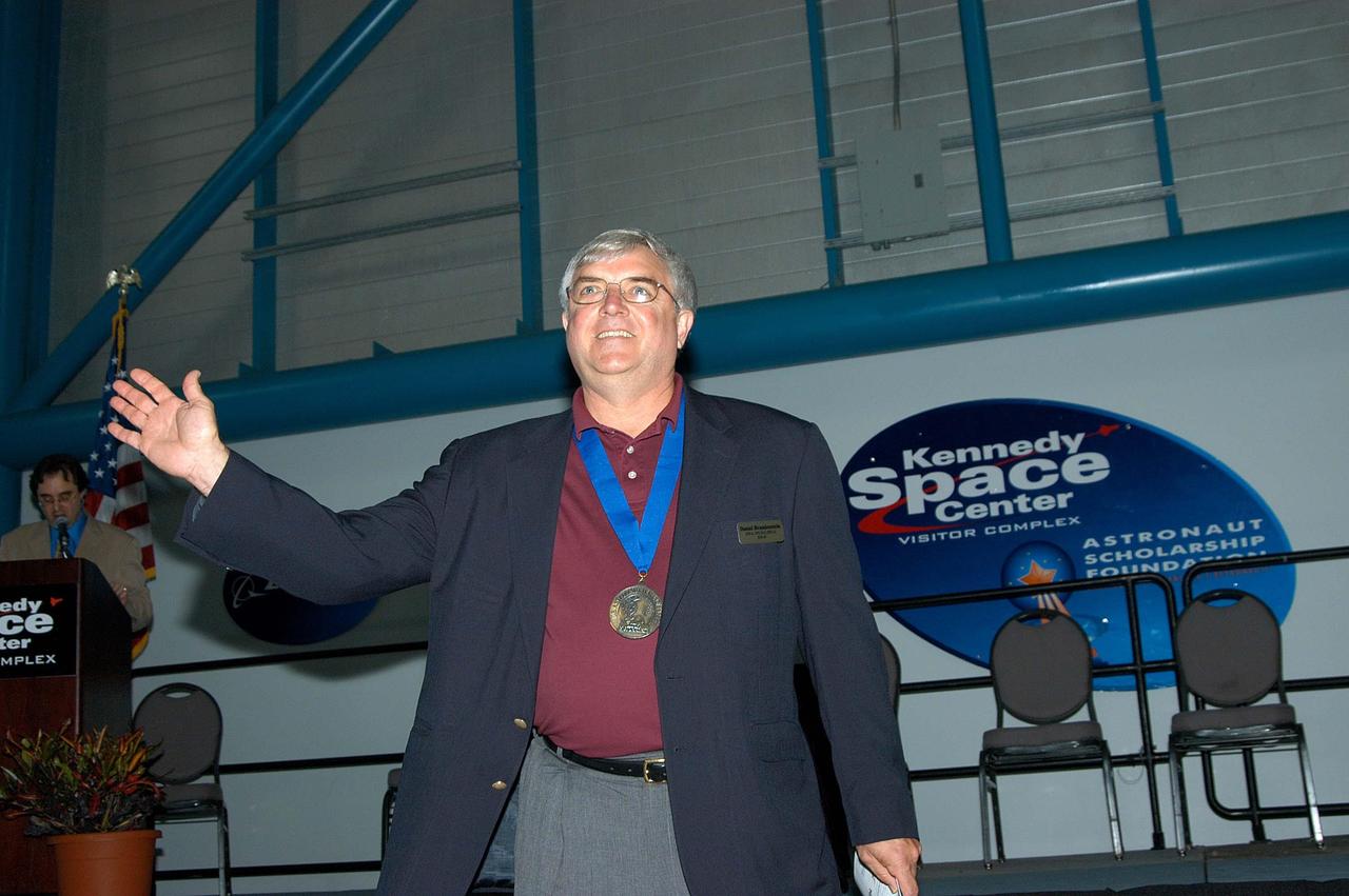 KENNEDY SPACE CENTER, FLA. -- Former astronaut Dan Brandenstein acknowledges the applause as he is introduced as a previous inductee into the U.S. Astronaut Hall of Fame.  He and other  Hall of Fame members were present for the induction of five new space program heroes into the U.S. Astronaut Hall of Fame: Richard O. Covey, commander of the Hubble Space Telescope repair mission; Norman E. Thagard, the first American to occupy Russia’s Mir space station; the late Francis R. "Dick" Scobee, commander of the ill-fated 1986 Challenger mission; Kathryn D. Sullivan, the first American woman to walk in space; and Frederick D. Gregory, the first African-American to command a space mission and the current NASA deputy administrator. Brandenstein piloted one Space Shuttle mission and commanded three others, including the maiden flight of Endeavour, and later served as chief of the Astronaut Office. The induction ceremony was held at the Apollo/Saturn V Center at KSC.  The U.S. Astronaut Hall of Fame opened in 1990 to provide a place where space travelers could be remembered for their participation and accomplishments in the U.S. space program. The five inductees join 52 previously honored astronauts from the ranks of the Gemini, Apollo, Skylab, Apollo-Soyuz, and Space Shuttle programs.