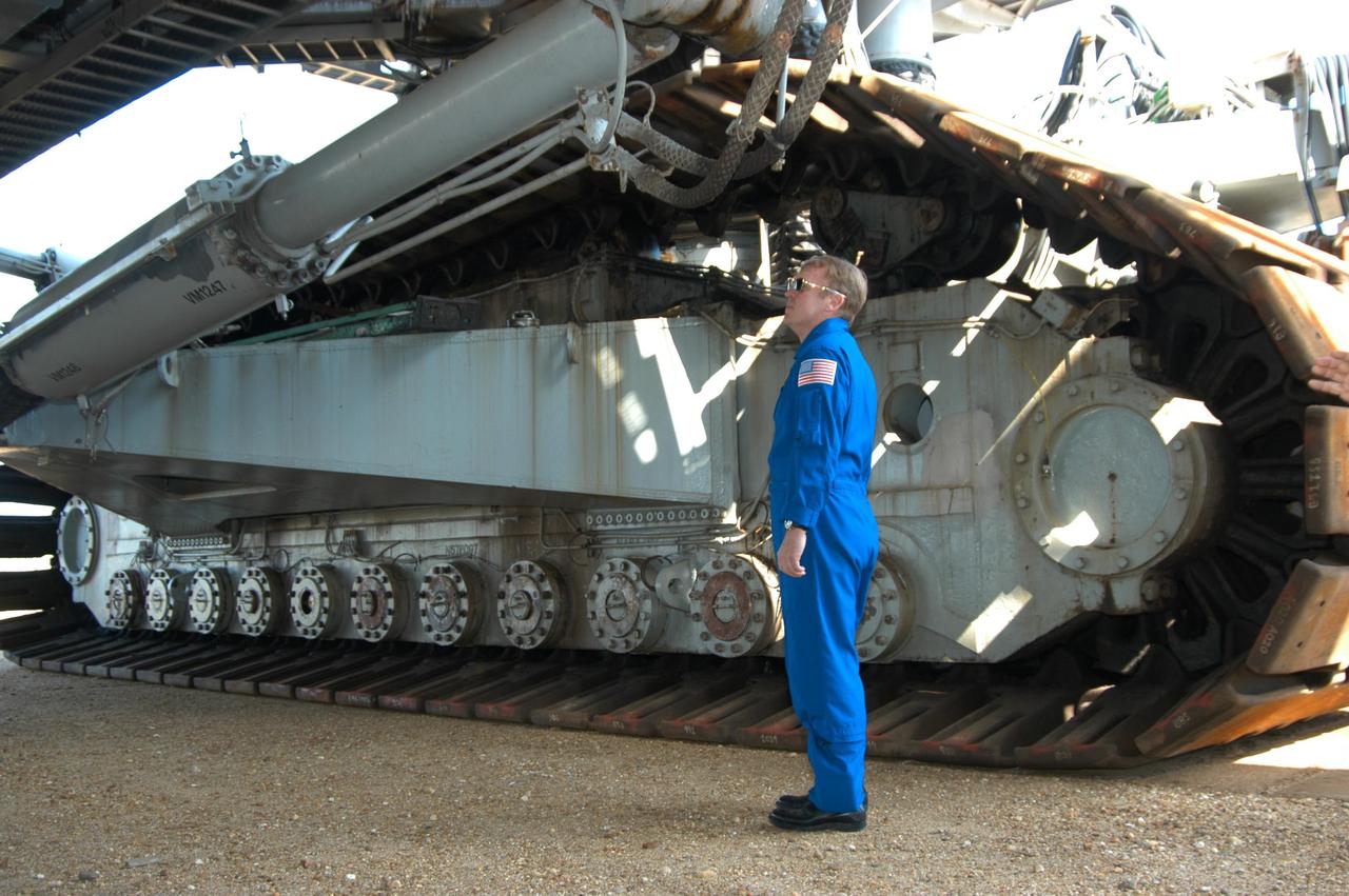 KENNEDY SPACE CENTER, FLA. -- STS-114 Mission Specialist Andrew Thomas stands next to the 10-foot-high track on a Crawler-Transporter. He and Pilot James Kelly toured the crawler storage area during a visit to KSC. The crawlers had recent modifications to the cab and muffler system. The STS-114 mission is Logistics Flight 1, which is scheduled to deliver supplies and equipment plus the external stowage platform to the International Space Station.
