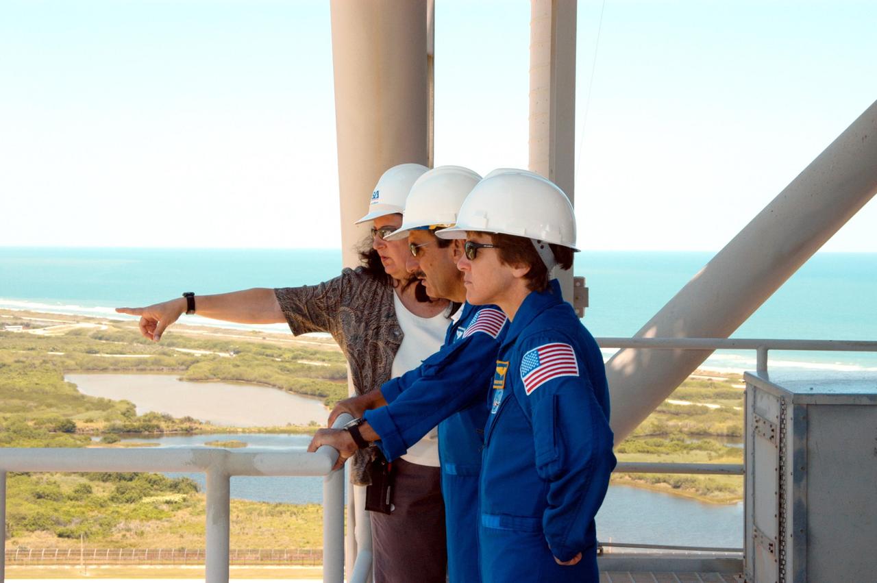 KENNEDY SPACE CENTER, FLA. -- From an upper level of the Fixed Service Structure on Launch Pad 39A, STS-114 Mission Specialists Charles Camarda (center) and Wendy Lawrence (right) look at the surrounding area.  Beyond the pad is the aqua blue Atlantic Ocean.  The STS-114 mission is Logistics Flight 1, which is scheduled to deliver supplies and equipment plus the external stowage platform to the International Space Station.