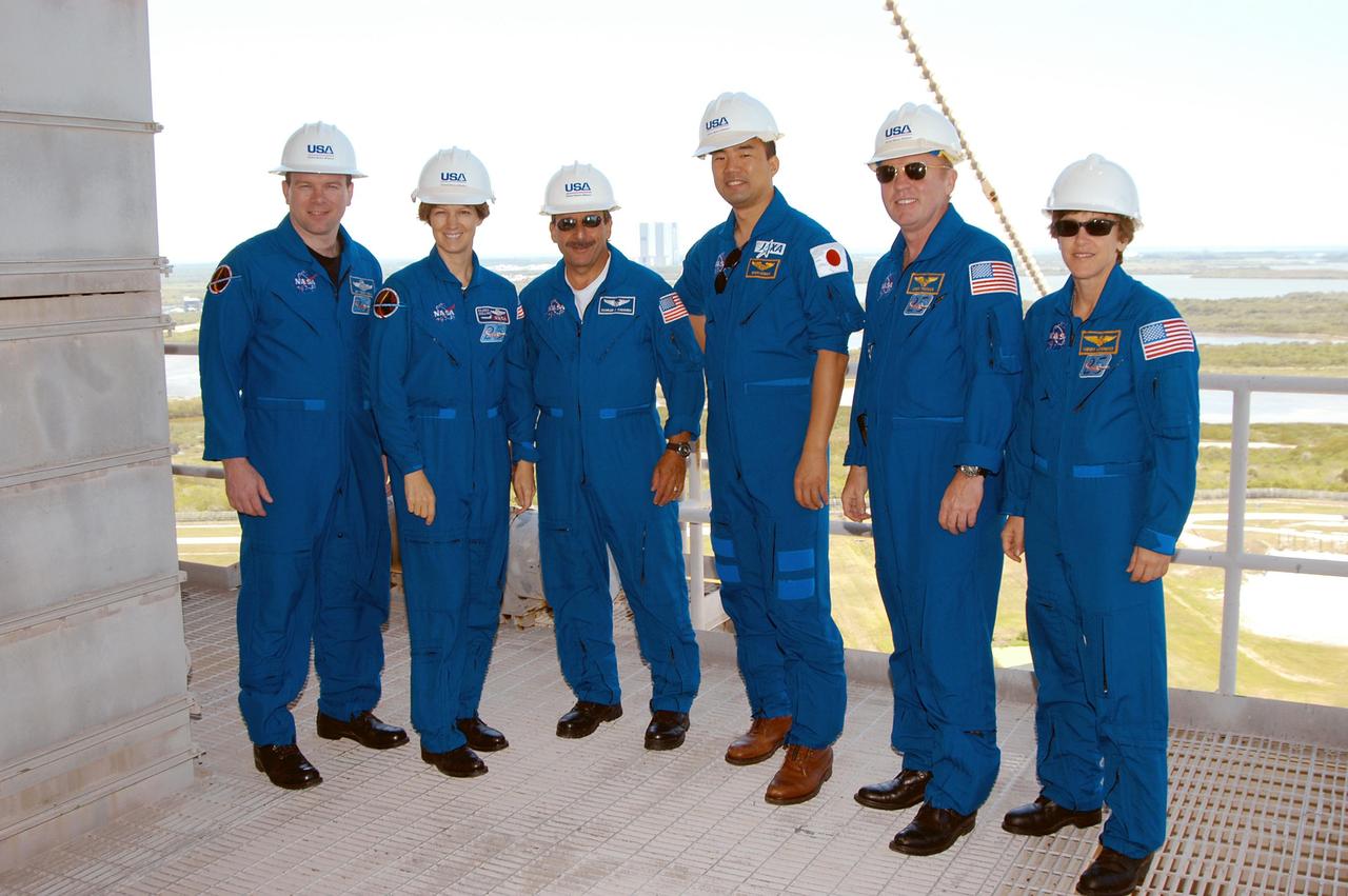 KENNEDY SPACE CENTER, FLA. -- The STS-114 crew poses on an upper level of Launch Pad 39A during their tour.   From left are Pilot James Kelly, Mission Commander Eileen Collins and Mission Specialists Charles Camarda, Soichi Noguchi, Andrew Thomas and Wendy Lawrence.  Noguchi represents the Japanese Aerospace and Exploration Agency. The STS-114 mission is Logistics Flight 1, which is scheduled to deliver supplies and equipment plus the external stowage platform to the International Space Station.