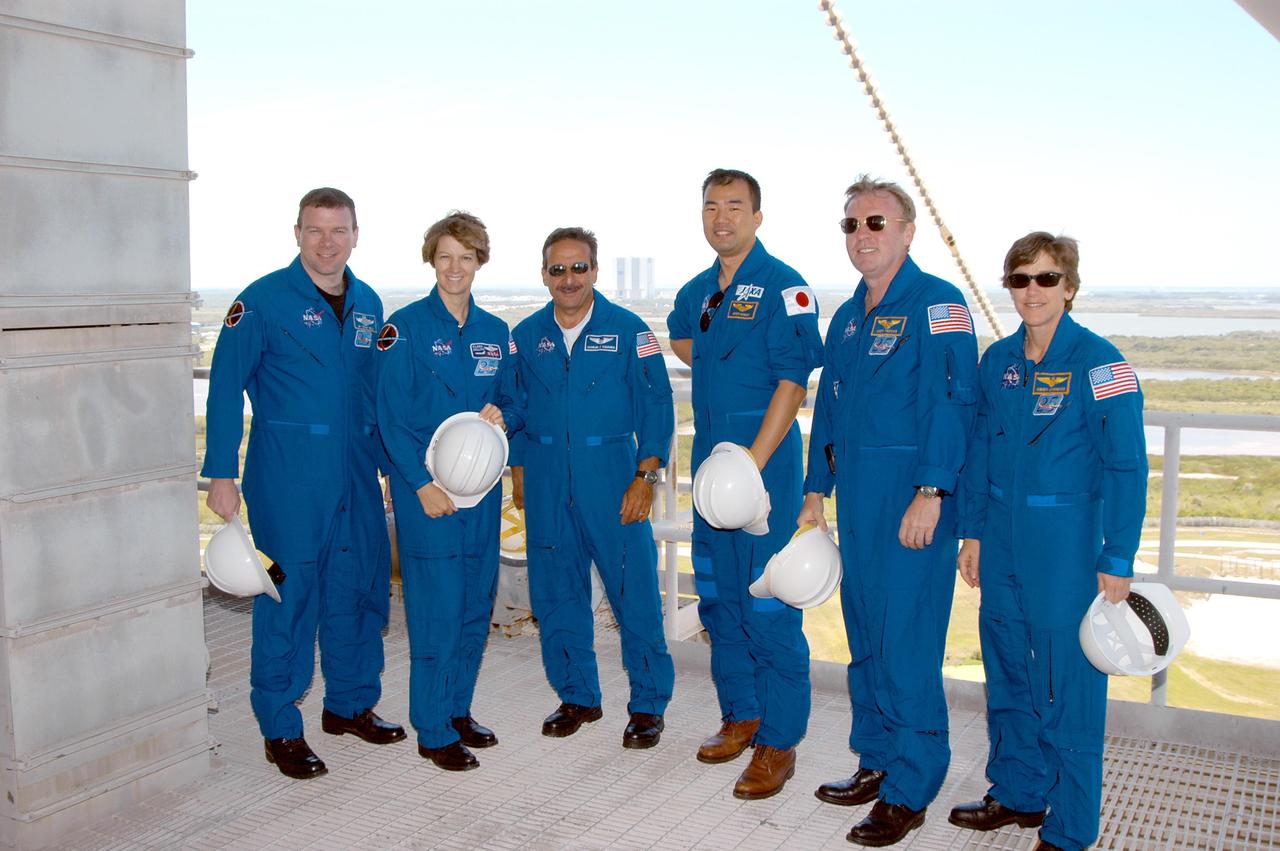 KENNEDY SPACE CENTER, FLA. -- The STS-114 crew poses on an upper level of Launch Pad 39A during their tour.   From left are Pilot James Kelly, Mission Commander Eileen Collins and Mission Specialists Charles Camarda, Soichi Noguchi, Andrew Thomas and Wendy Lawrence.  Noguchi represents the Japanese Aerospace and Exploration Agency.  The STS-114 mission is Logistics Flight 1, which is scheduled to deliver supplies and equipment plus the external stowage platform to the International Space Station.
