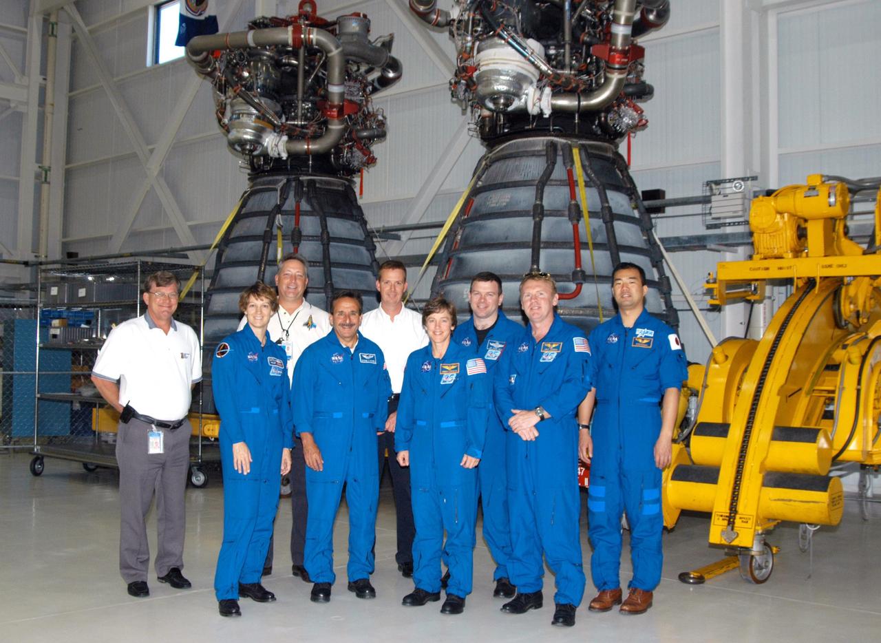 KENNEDY SPACE CENTER, FLA. -- In the Space Shuttle Main Engine Shop at KSC, the STS-114 crew poses for a photo in front of two of the main engines.  Crew members, from left, are Mission Commander Eileen Collins, Mission Specialists Charles Camarda and Wendy Lawrence, Pilot James Kelly, and Mission Specialists Andrew Thomas and Soichi Noguchi, who represents the Japanese Aerospace and Exploration Agency.  Behind them are Dan Hausman (director, Product Support, Boeing), Dan Sweety (manager, Safety & Mission Assurance, Boeing)  and Matt McClelland (team manager, Tech Ops, Boeing).  The STS-114 mission is Logistics Flight 1, which is scheduled to deliver supplies and equipment plus the external stowage platform to the International Space Station.