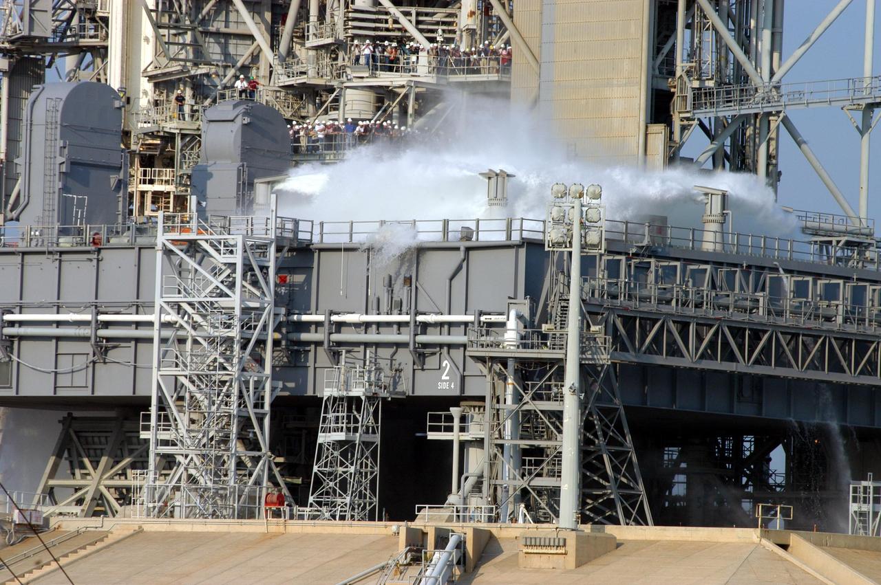 KENNEDY SPACE CENTER, FLA. -- For the fourth time in Space Shuttle Program history, 350,000 gallons of water are released on a Mobile Launcher Platform (MLP) at Launch Pad 39A during a water sound suppression test. This test is being conducted following the replacement of the six main system valves, which had been in place since the beginning of the Shuttle Program and had reached the end of their service life. Also, the hydraulic portion of the valve actuators has been redesigned and simplified to reduce maintenance costs. The sound suppression water system is installed on the launch pads to protect the orbiter and its payloads from damage by acoustical energy reflected from the MLP during launch. The system includes an elevated water tank with a capacity of 300,000 gallons. The tank is 290 feet high and stands on the northeast side of the Pad. The water is released just before the ignition of the orbiter's three main engines and twin solid rocket boosters, and flows through parallel 7-foot-diameter pipes to the Pad area.