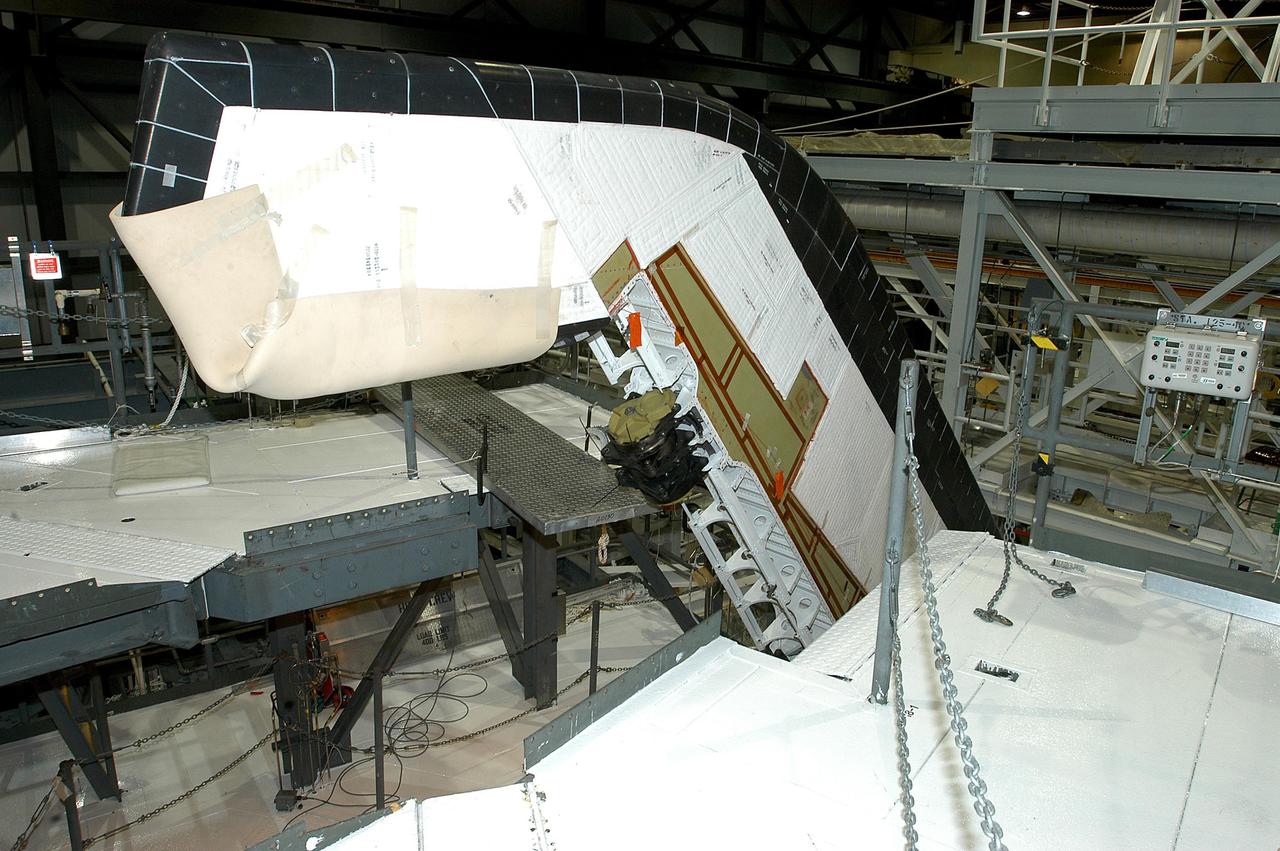 KENNEDY SPACE CENTER, FLA. -- A Rudder Speed Brake Actuator is being removed from the orbiter Atlantis for shipment to the vendor for inspection. An actuator is a motor that moves the tail rudder back and forth to help steer it during landing and brake its speed. The vertical tail consists of a structural fin surface made of aluminum, the Rudder Speed Brake surface, a tip and a lower trailing edge. The rudder splits into two halves to serve as a speed brake. The vertical tail and Rudder Speed Brake are covered with a reusable thermal protection system. Atlantis is undergoing maintenance and inspection in the Orbiter Processing Facility for a future mission.
