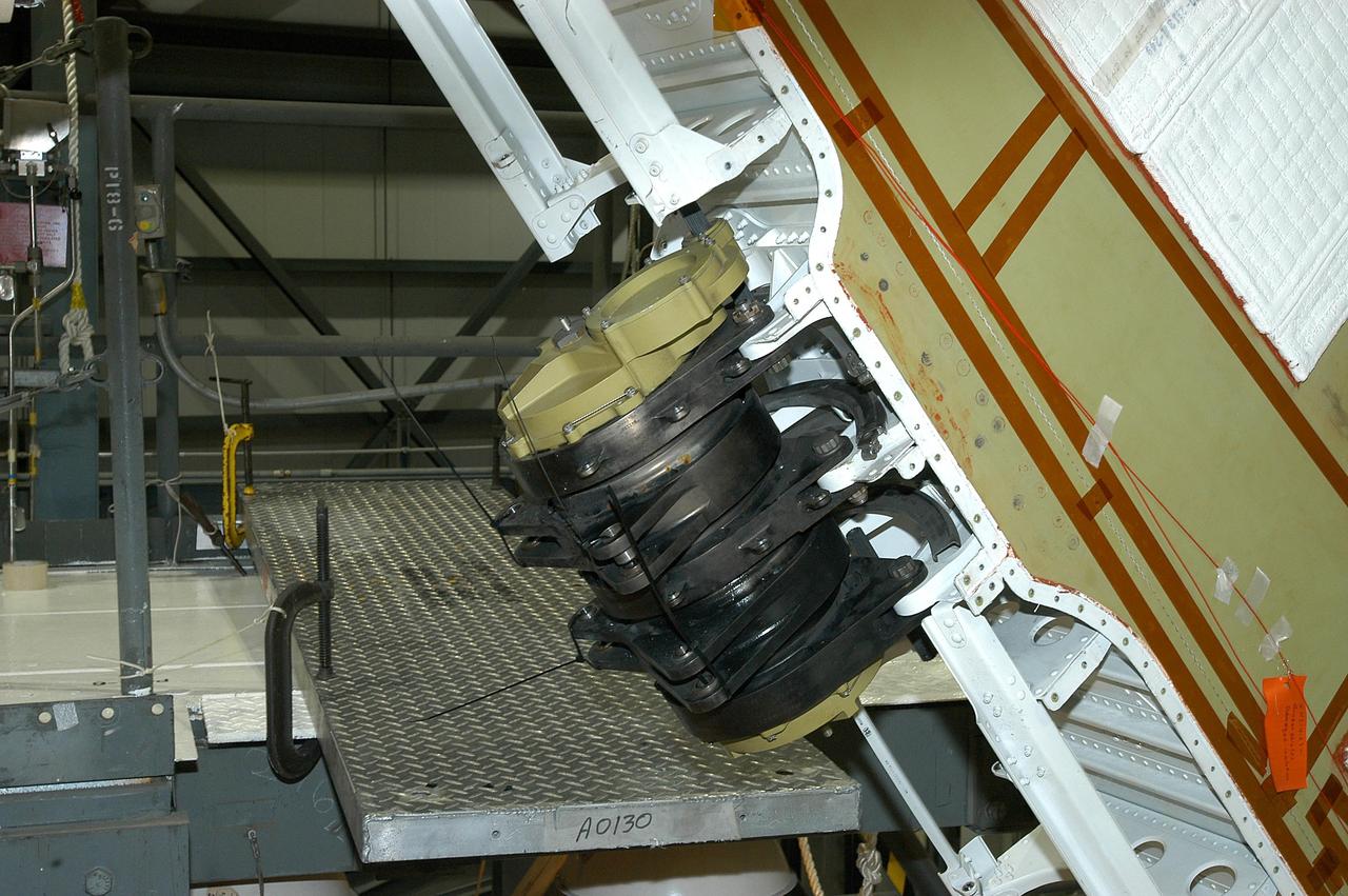 KENNEDY SPACE CENTER, FLA. -- This is a closeup of one of the Rudder Speed Brake Actuators that are being removed from the orbiter Atlantis for shipment to the vendor for inspection. An actuator is a motor that moves the tail rudder back and forth to help steer it during landing and brake its speed. The vertical tail consists of a structural fin surface made of aluminum, the Rudder Speed Brake surface, a tip and a lower trailing edge. The rudder splits into two halves to serve as a speed brake. The vertical tail and Rudder Speed Brake are covered with a reusable thermal protection system. Atlantis is undergoing maintenance and inspection in the Orbiter Processing Facility for a future mission.
