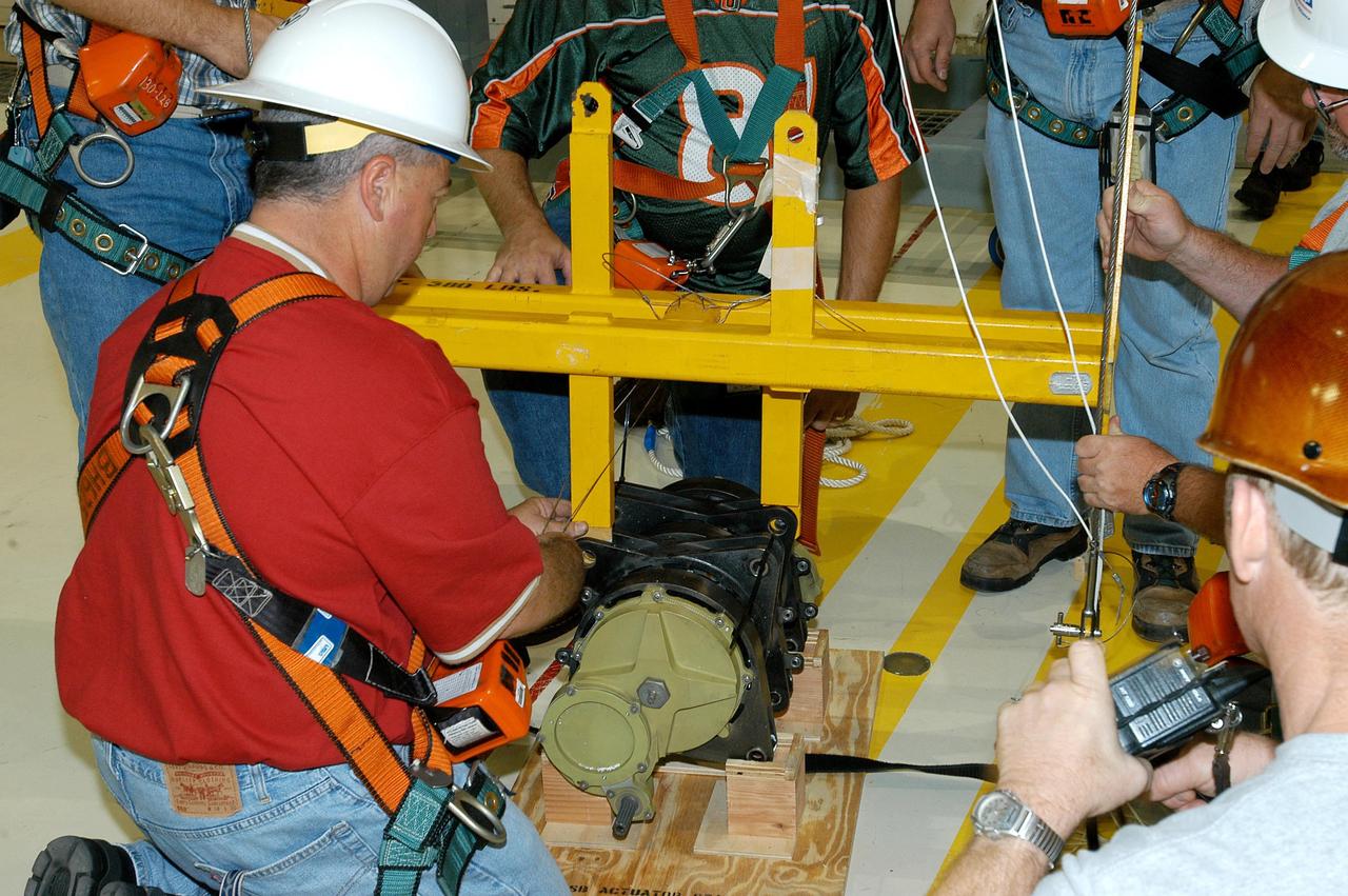 KENNEDY SPACE CENTER, FLA. -- A Rudder Speed Brake Actuator from the orbiter Atlantis is set on a stand on the floor of the Orbiter Processing Facility. This and three other actuators are being shipped to the vendor for inspection. An actuator is a motor that moves the tail rudder back and forth to help steer it during landing and brake its speed. The vertical tail consists of a structural fin surface made of aluminum, the Rudder Speed Brake surface, a tip and a lower trailing edge. The rudder splits into two halves to serve as a speed brake. The vertical tail and Rudder Speed Brake are covered with a reusable thermal protection system. Atlantis is undergoing maintenance and inspection for a future mission.