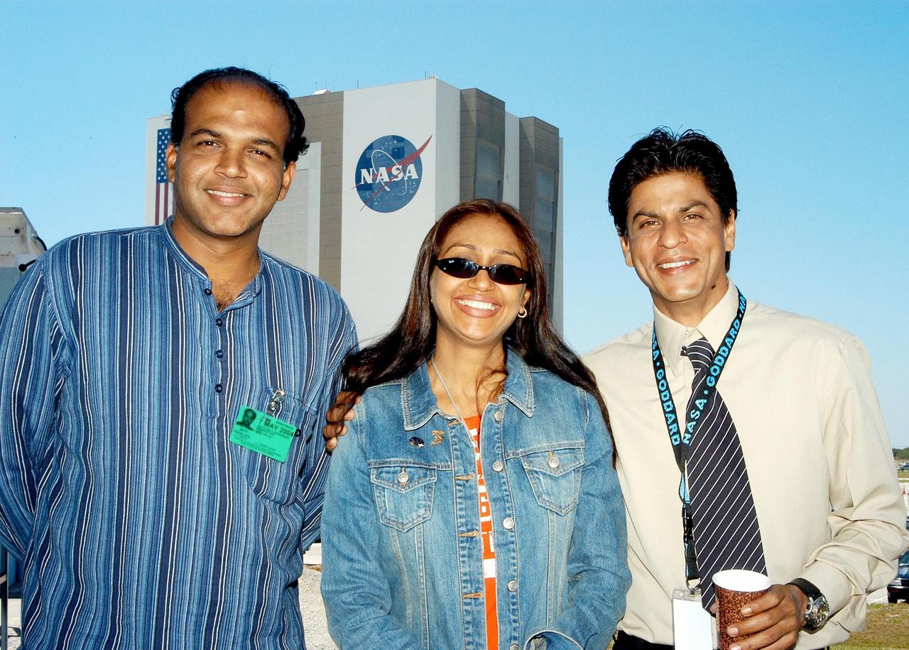 KENNEDY SPACE CENTER, FLA. -- During filming at KSC, writer-director from India Ashutosh Gowariker, his wife Sunita, and actor Shahrukh Khan pose for a photo with the Vehicle Assembly Building in the background.   The film crew spent several days at KSC filming at various sites for the movie “Swades,” a story about India’s brain-drain.  Khan is one of the lead actors in the film; the other is Gayatri Joshi. Sunita Gowariker is executive producer.