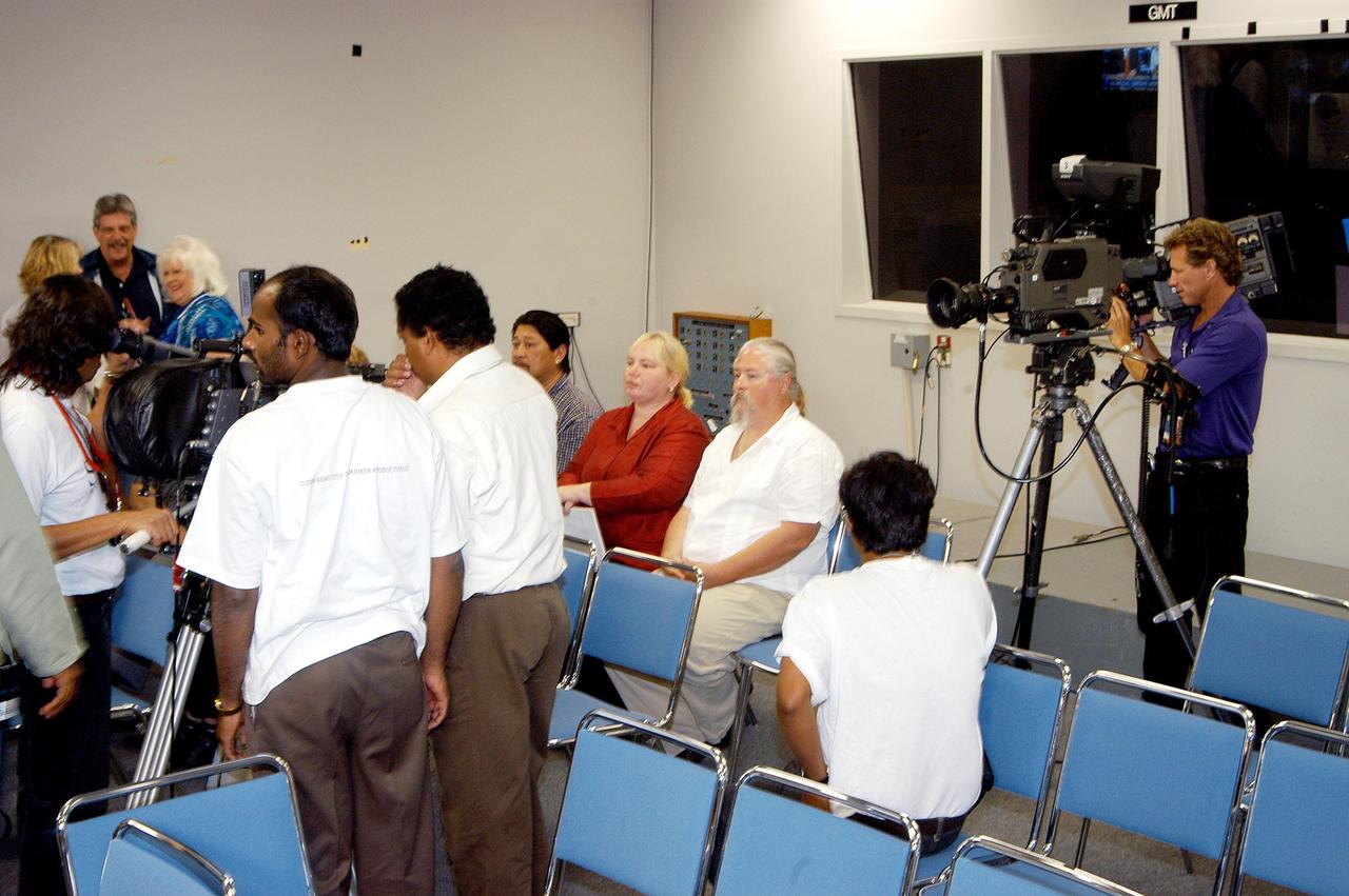 KENNEDY SPACE CENTER, FLA. -- KSC videographer Dave Stanley, at right, films the crew from India who are setting up their equipment.  The crew spent several days at KSC filming at various sites for the movie “Swades,” a story about India’s brain-drain.  The writer and director  is Ashutosh Gowariker (seen to the right of center).  The lead actors are Shahrukh Khan and Gayatri Joshi. Sunita Gowariker is executive producer.