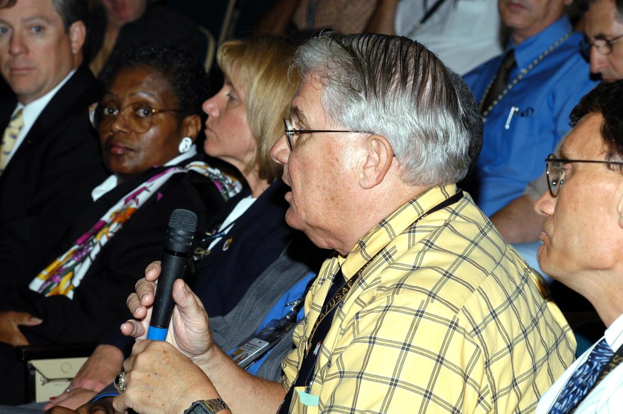 KENNEDY SPACE CENTER, FLA. -- A KSC employee asks a question of the panel conducting the Culture Change Process All Hands Meeting in the Training Auditorium.  The purpose of the meeting was for employees to gain further insight into the Agency’s Vision for Space Exploration and the direction cultural change will take at KSC in order to assume its role within this vision. Panel members included James W. Kennedy, KSC director; Jim Jennings, Deputy Associate Administrator for Institutions and Asset Management; Lynn Cline, Deputy Associate Administrator for Space Flight; Bob Sieck, former Director of Space Shuttle Processing at KSC; and Jim Wetherbee, astronaut and Technical Assistant to the Director of Safety and Mission Assurance at the Johnson Space Center.