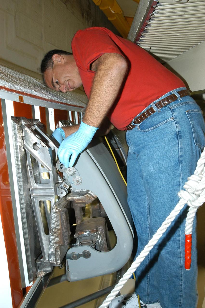 KENNEDY SPACE CENTER, FLA. -- In the Orbiter Processing Facility, technician Mike McCall installs a reinforced carbon carbon panel on the right wing of Space Shuttle Discovery. The next flight planned for Discovery is the STS-114 mission on Logistics Flight 1 to deliver supplies and equipment, as well as the external stowage platform, to the International Space Station. STS-114 will be the mission that returns the Space Shuttle to flight status and is scheduled for no earlier than March 2005.