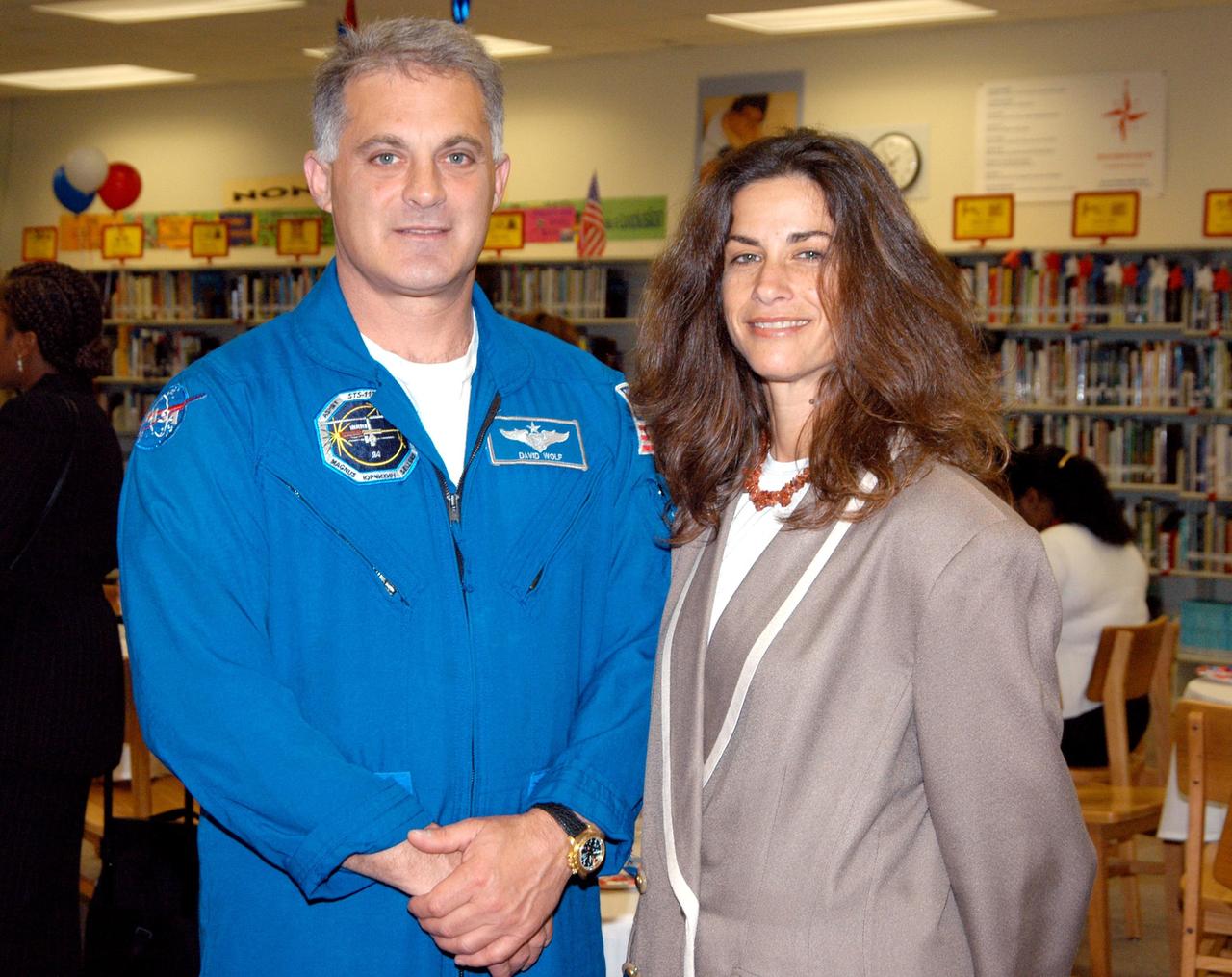 KENNEDY SPACE CENTER, FLA. -- During lunch in the library at Howard A. Doolin Middle School, Miami, Fla., astronaut David Wolf pauses for a photo with a member of the school board. Doolin Middle School is one of 100 to take part in the NASA Explorer Schools program. Wolf joined Center Director Jim Kennedy to share America’s new vision for space exploration with the next generation of explorers. Kennedy is talking with students about our destiny as explorers, NASA’s stepping stone approach to exploring Earth, the Moon, Mars and beyond, how space impacts our lives, and how people and machines rely on each other in space.