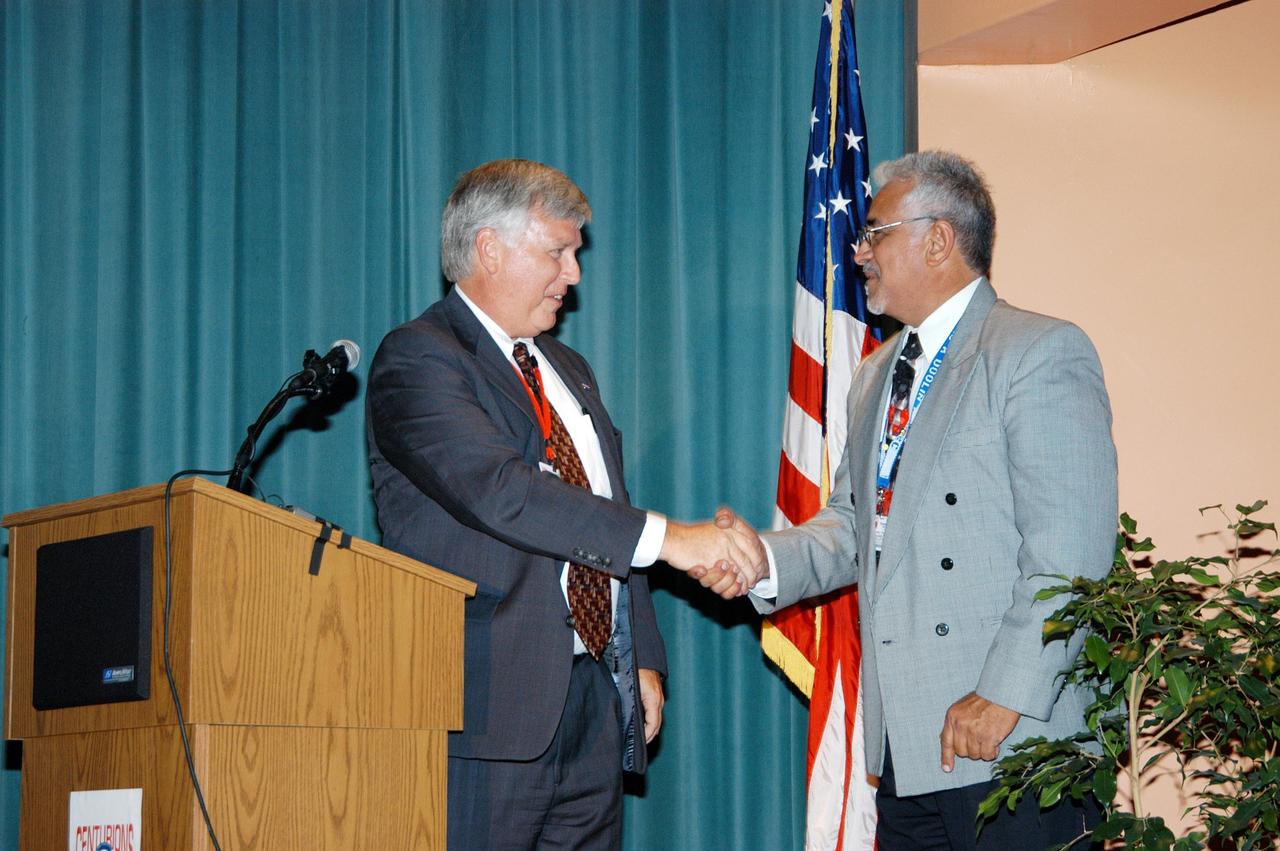 KENNEDY SPACE CENTER, FLA. -- Center Director Jim Kennedy (left) is thanked by Principal Eduardo Tillet for his presentation to the faculty and students of Howard A. Doolin Middle School, Miami, Fla. The school is one of 100 taking part in the NASA Explorer Schools (NES) program. The purpose of Kennedy’s visit is to share America’s new vision for space exploration with the next generation of explorers. He is talking with students in Florida and Georgia Explorer Schools about our destiny as explorers, NASA’s stepping stone approach to exploring Earth, the Moon, Mars and beyond, how space impacts our lives, and how people and machines rely on each other in space.