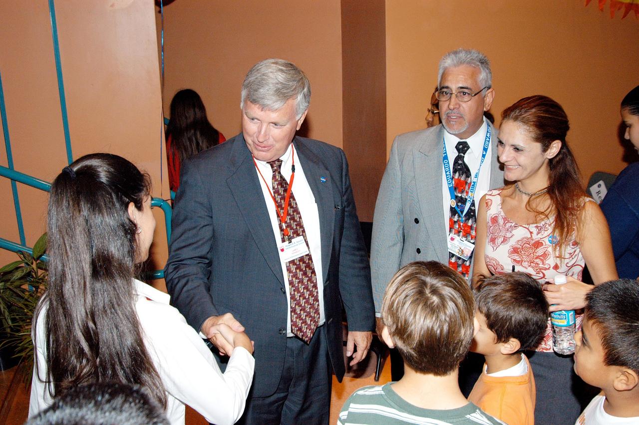 KENNEDY SPACE CENTER, FLA. -- Center Director Jim Kennedy (center) greets a student after his presentation at Howard A. Doolin Middle School, Miami, Fla. The school is one of 100 taking part in the NASA Explorer Schools (NES) program. The purpose of Kennedy’s visit is to share America’s new vision for space exploration with the next generation of explorers. He is talking with students in Florida and Georgia Explorer Schools about our destiny as explorers, NASA’s stepping stone approach to exploring Earth, the Moon, Mars and beyond, how space impacts our lives, and how people and machines rely on each other in space.